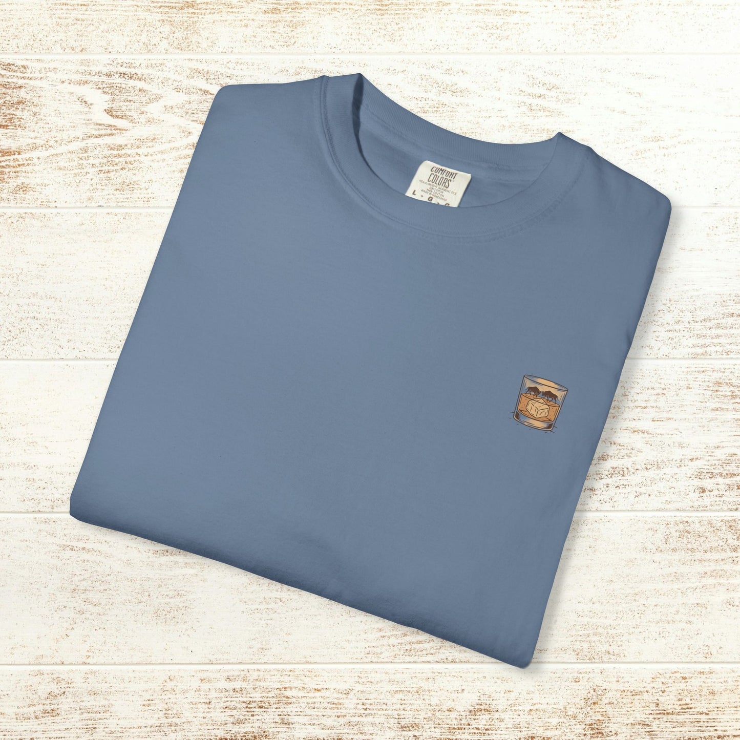 Rodeo On The Rocks Tee displayed flat, featuring a soft 100% US cotton fabric and garment-dyed style, ideal for casual wear.