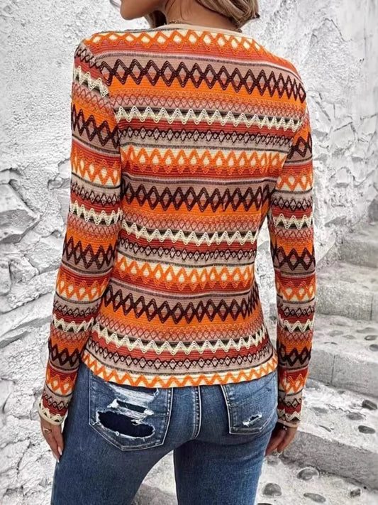 Trendy Bohemian Geometric Long Sleeve T-Shirt featuring a vibrant orange and brown pattern, paired with distressed blue jeans, perfect for stylish casual wear.