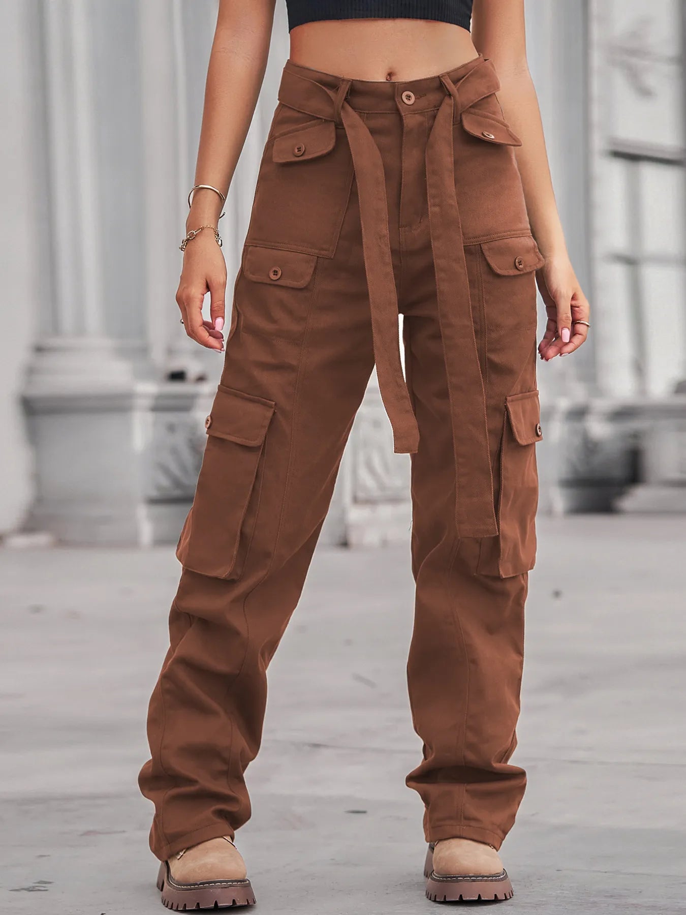 High-Waisted Multi-Pocket Cargo Jeans highlighted by a model wearing brown cargo jeans, styled with a belted waist and multiple pockets for fashion and function.