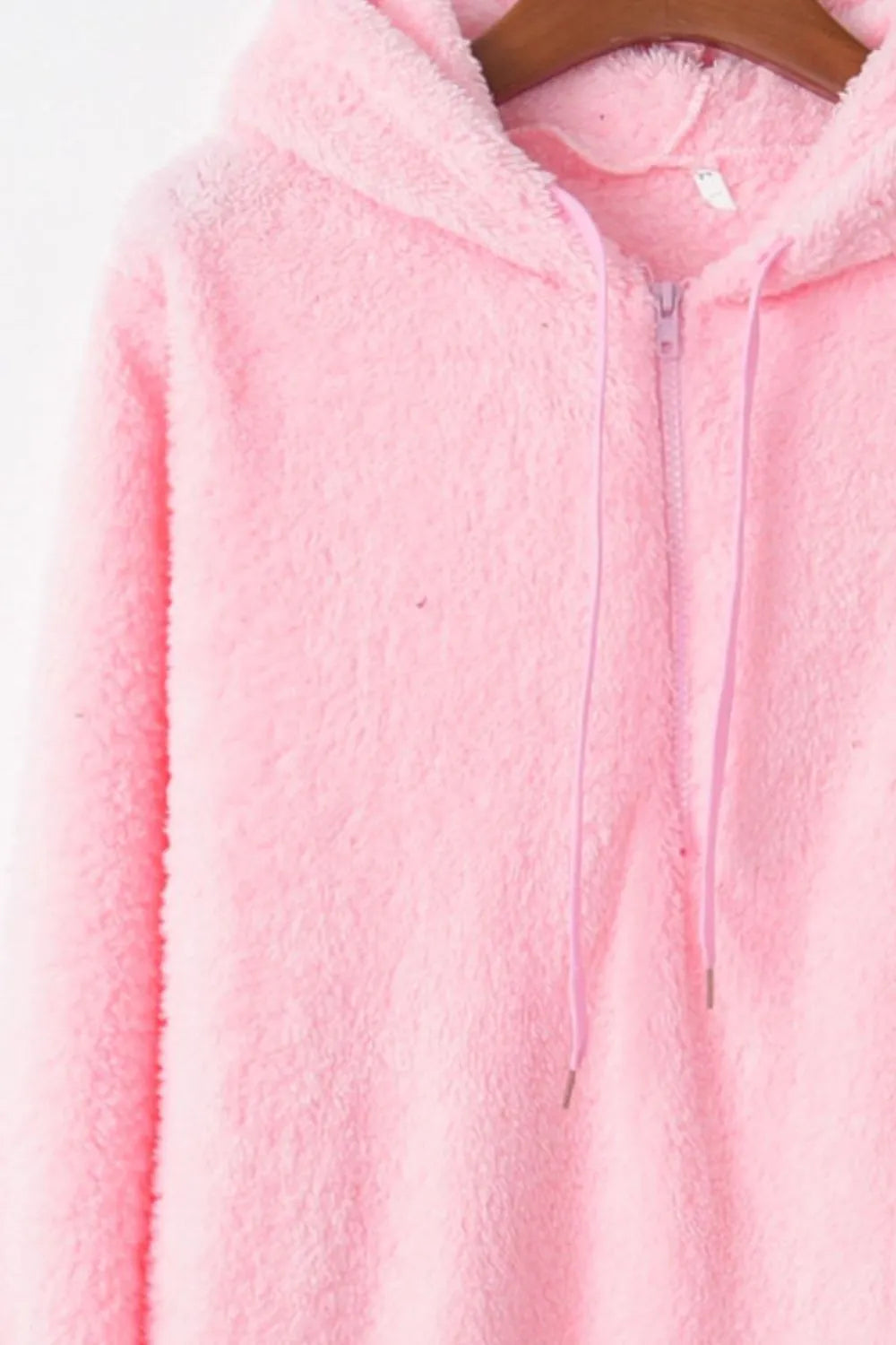 Close-up view of the Cozy Full Size Teddy Hoodie with Quarter-Zip and Drawstring highlighting its fluffy texture and zipper detail.