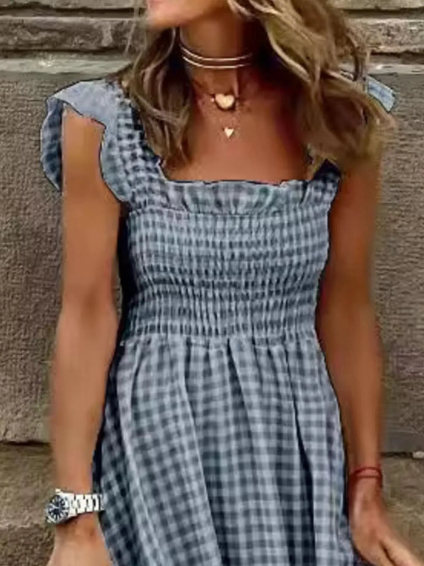 Close-up of a Gingham Maxi Dress featuring Ruffle Straps and a Smocked Bodice design by Trendsi, showcasing its elegant, feminine details.