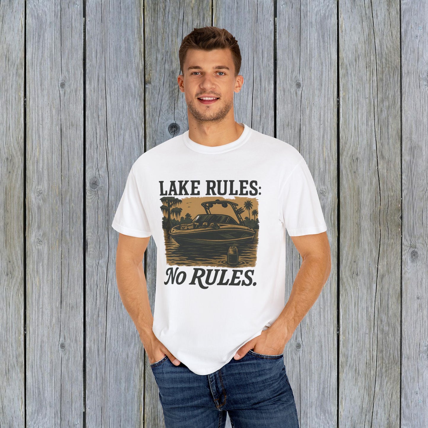 A young man wearing the Unisex Garment-Dyed Lake Rules Tee in white, displaying the graphic print that embodies lake lifestyle and adventure.