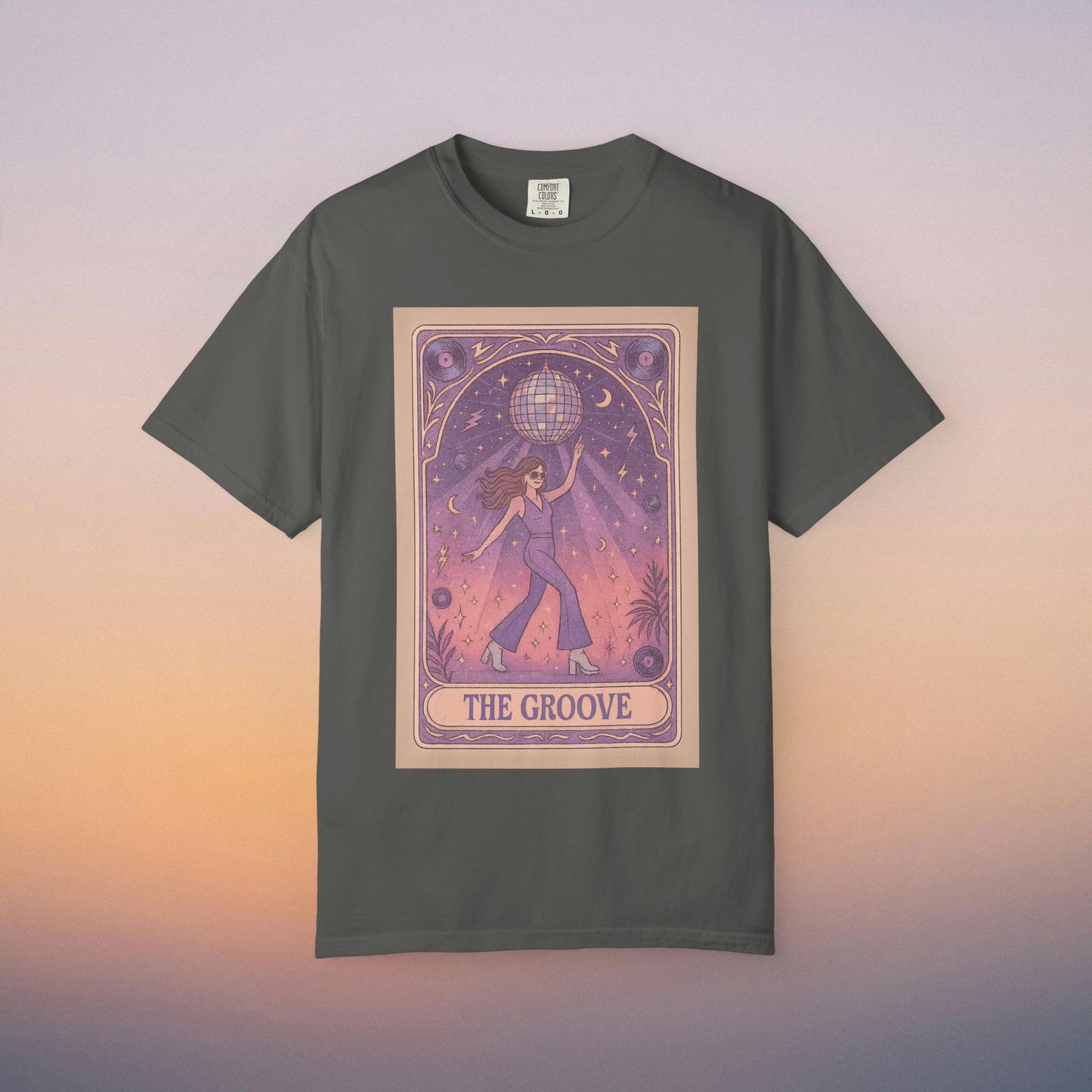 Groove Tarot Graphic Tee in dark gray, showcasing a unique illustration of a character balancing a globe against a mystical starry backdrop. Crafted from 100% ring-spun cotton, this unisex tee is offered in sizes S-4XL.