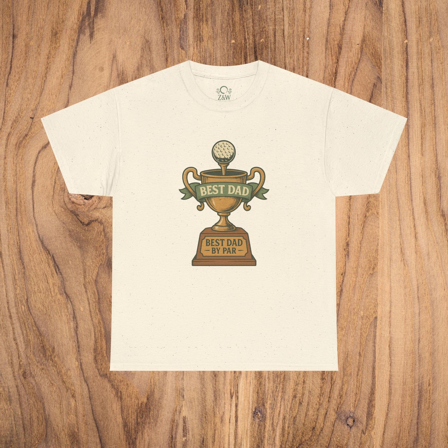 Best Dad Trophy T-Shirt displayed on a wooden background, featuring a stylish graphic of a trophy with a golf ball and the inscription 'BEST DAD BY PAR', made from soft cotton for comfort.