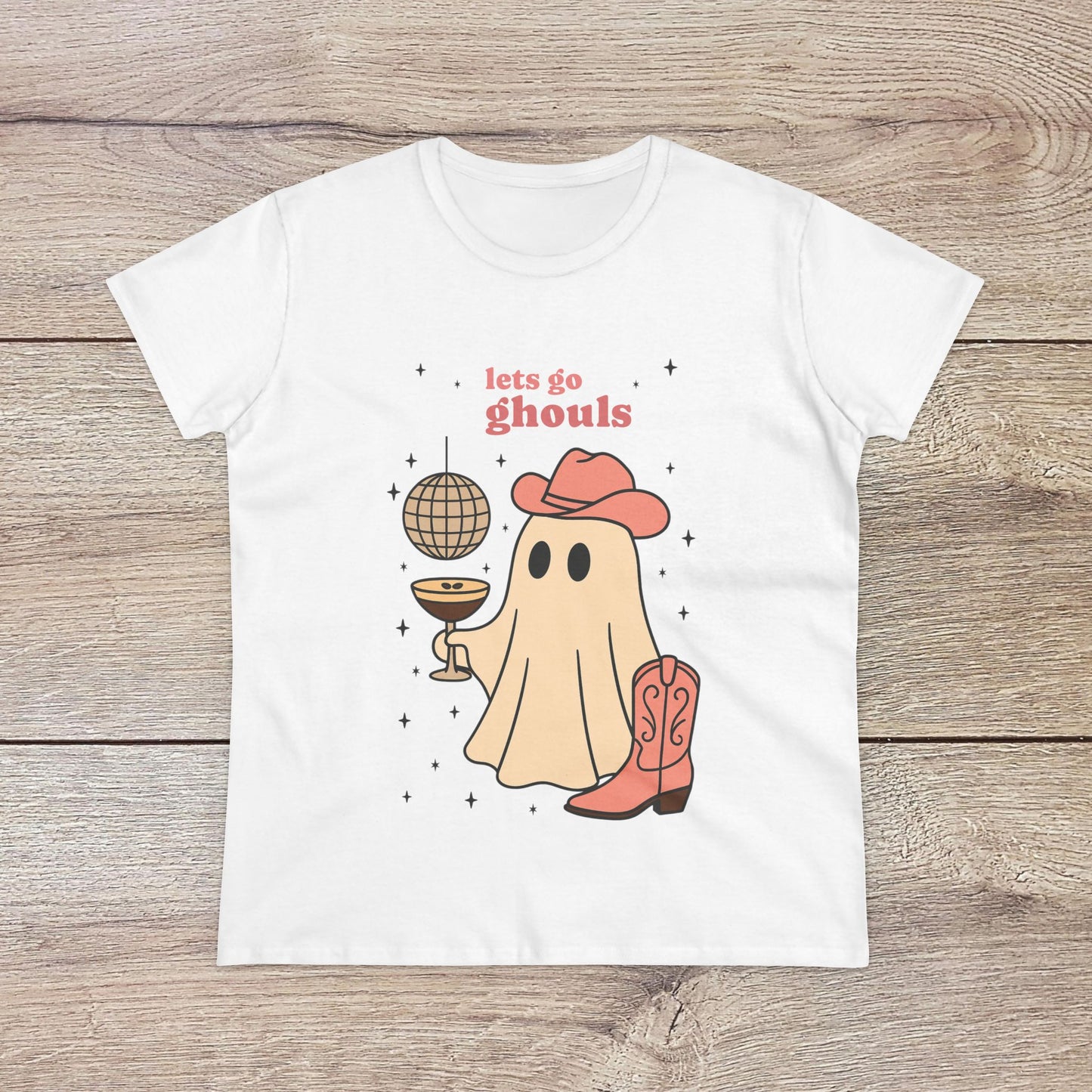 Let's Go Ghouls Tee featuring a cute ghost in a cowboy hat, holding a disco ball, perfect for Halloween festivities. Available in soft, 100% cotton material.