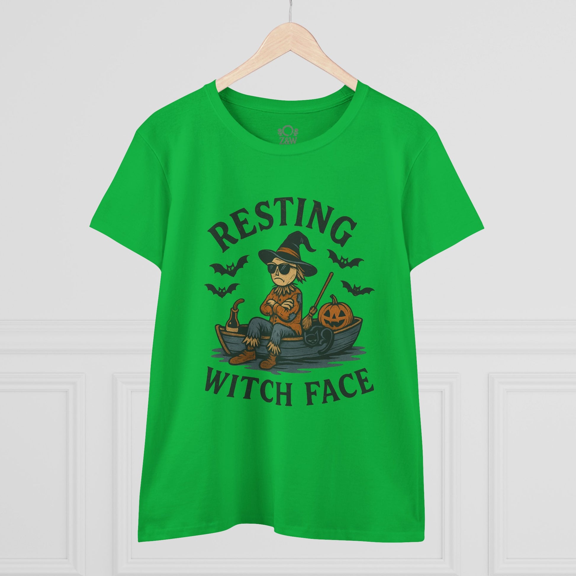 Resting Witch Face Halloween T-Shirt for Women, featuring a fun graphic of a witch on a boat with pumpkins, perfect for parties and gifts. Bright green color highlights the playful design.