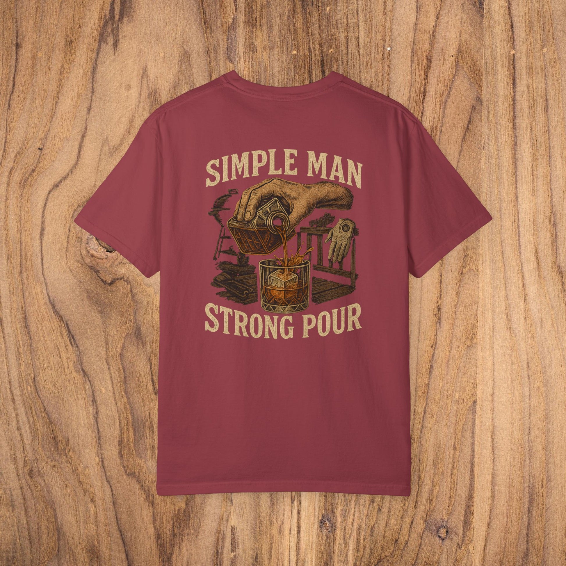 Simple Man Strong Pour T-Shirt in maroon, featuring a creative graphic of a hand pouring into a glass; ideal for a fashionable and comfortable everyday look.