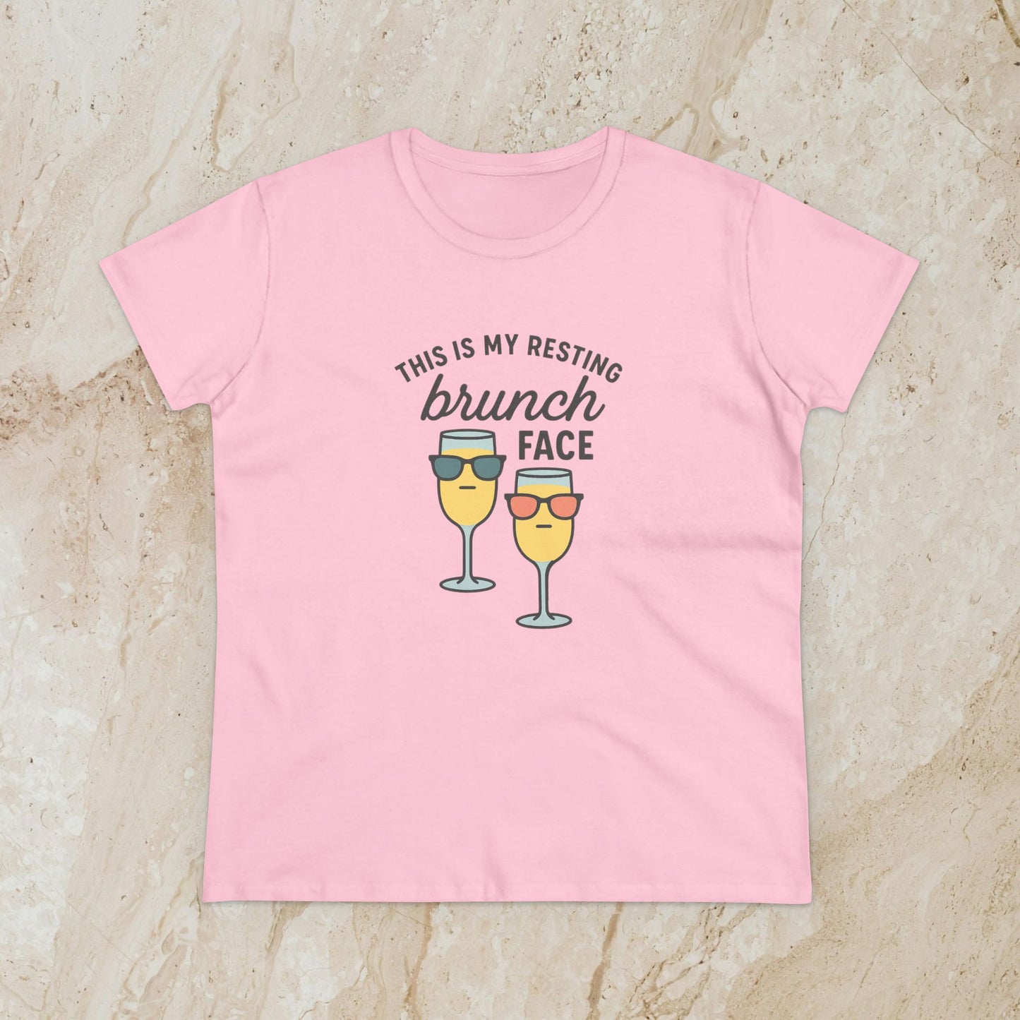 Women's Premium 100% Cotton Brunch Face Tee in light pink with a whimsical print of two cocktails with sunglasses stating 'THIS IS MY RESTING brunch FACE'. The perfect tee for stylish brunch occasions.