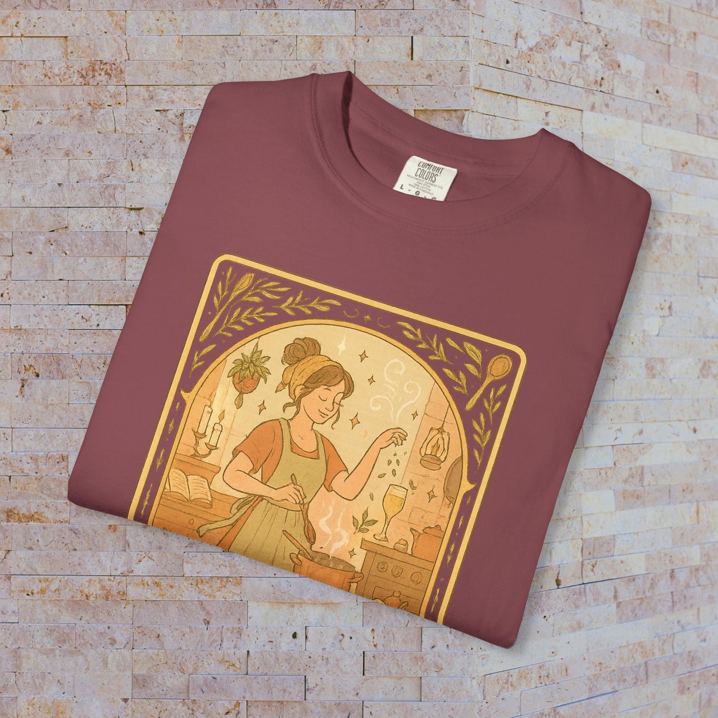 Culinary Queen Tarot Tee in burgundy, featuring an artistic design of a woman in the kitchen, ideal for culinary fans. Offered in a wide range of sizes from S to 4XL, made from soft pre-shrunk cotton.
