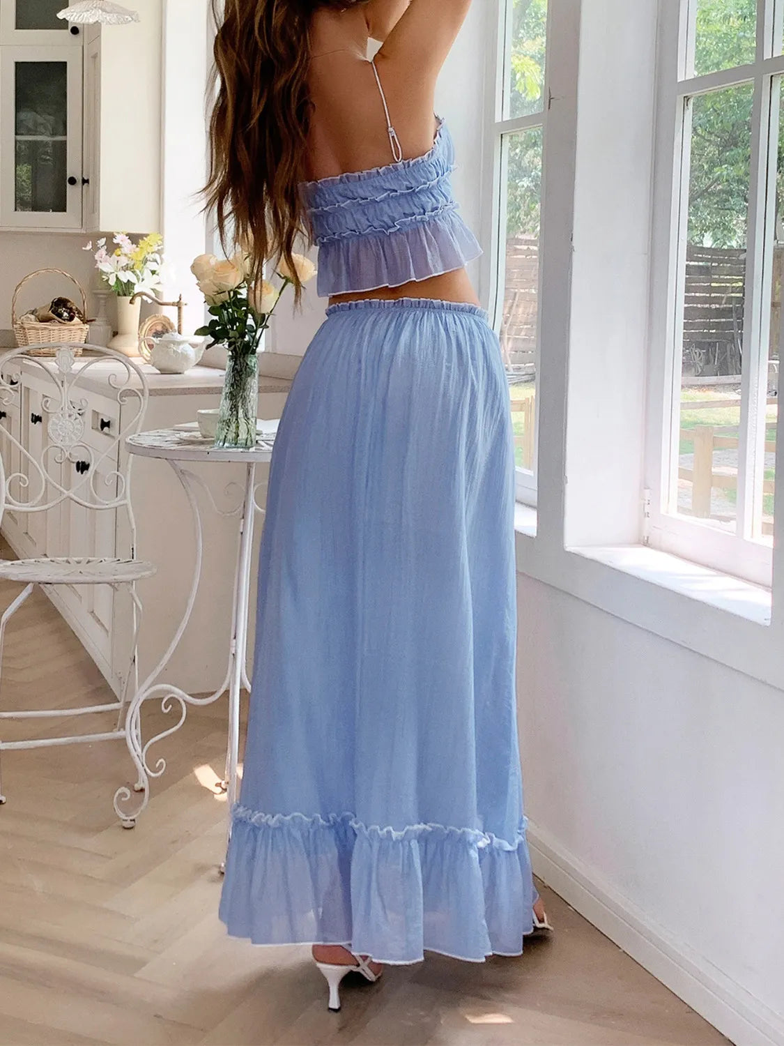 Back view of model in a Two-Piece Frill Square Neck Cami and Ruched Skirt Set in Stretchy Lyocell Blend, showcasing the light blue fabric and layered design.