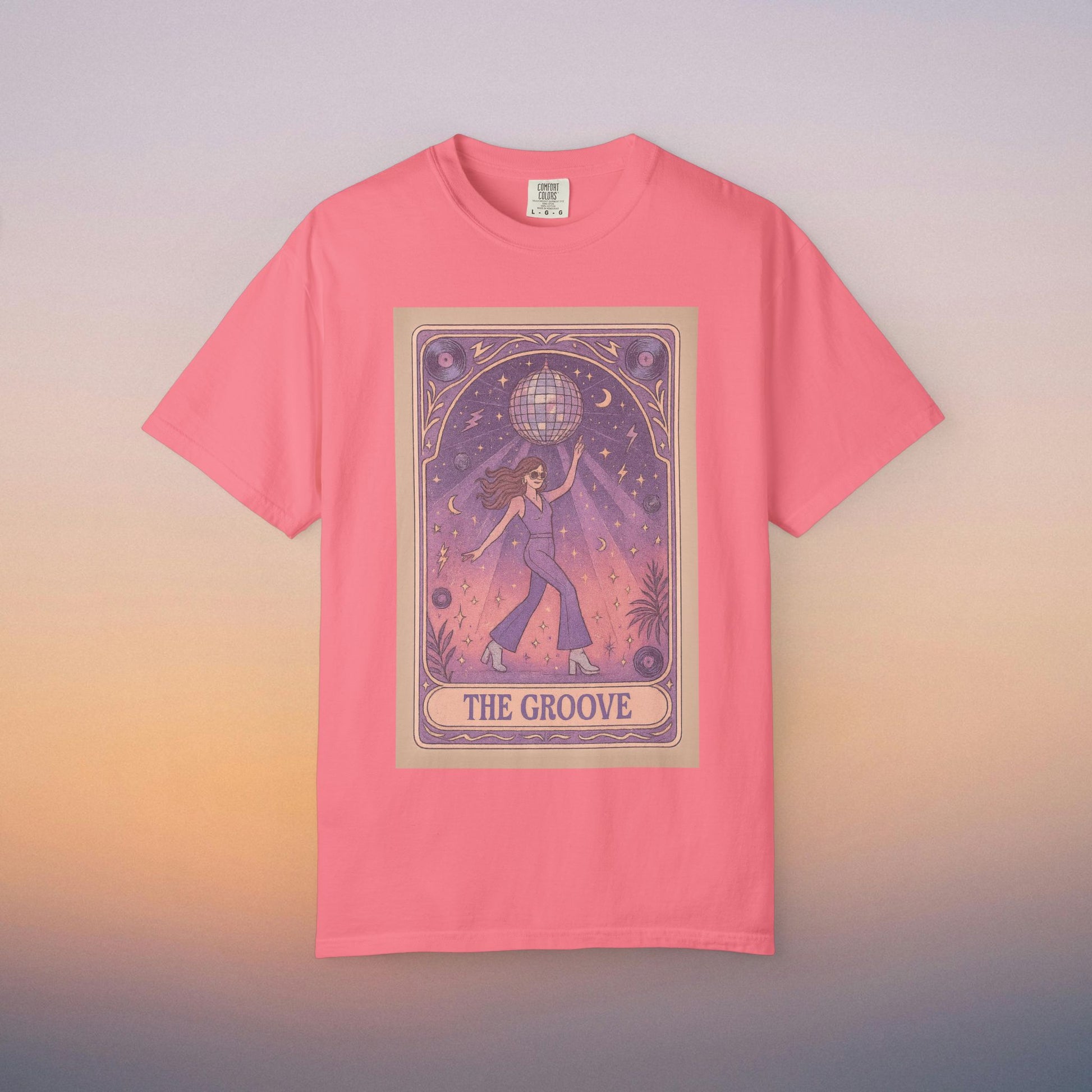 Groove Tarot Graphic Tee in vibrant pink, displaying an eye-catching design of a character holding a globe surrounded by stars. Crafted from 100% ring-spun cotton, this unisex tee comes in sizes S-4XL for everyone.