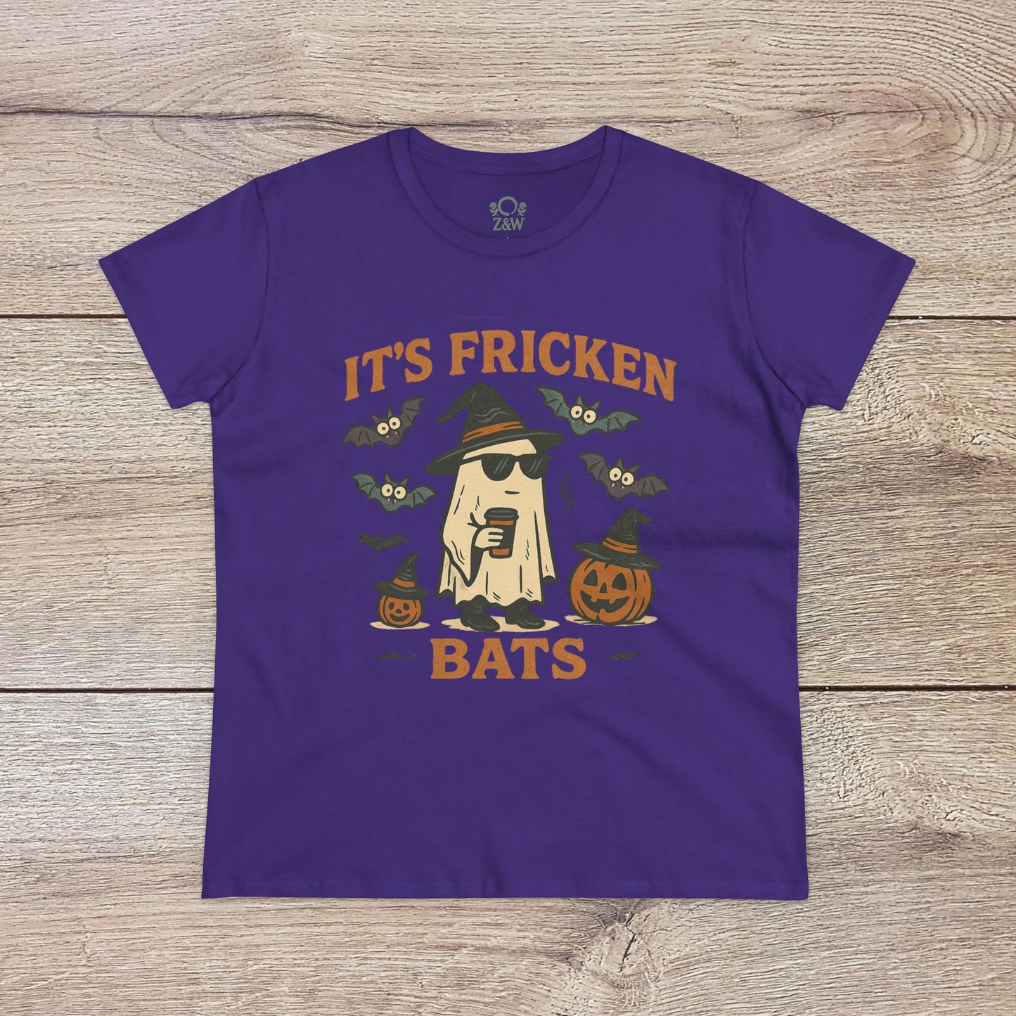 Halloween Unisex T-Shirt in purple displaying a playful ghost graphic with bats and pumpkins. Crafted from 100% cotton, ideal for trick-or-treating.