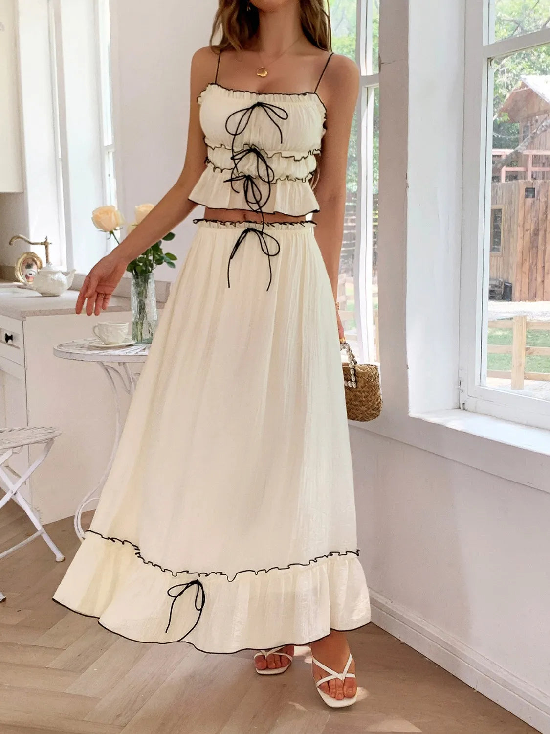 Another view of a Model wearing the Two-Piece Frill Square Neck Cami and Ruched Skirt Set in Stretchy Lyocell Blend, demonstrating its delicate design with frill details and adjustable ties for a flattering fit.