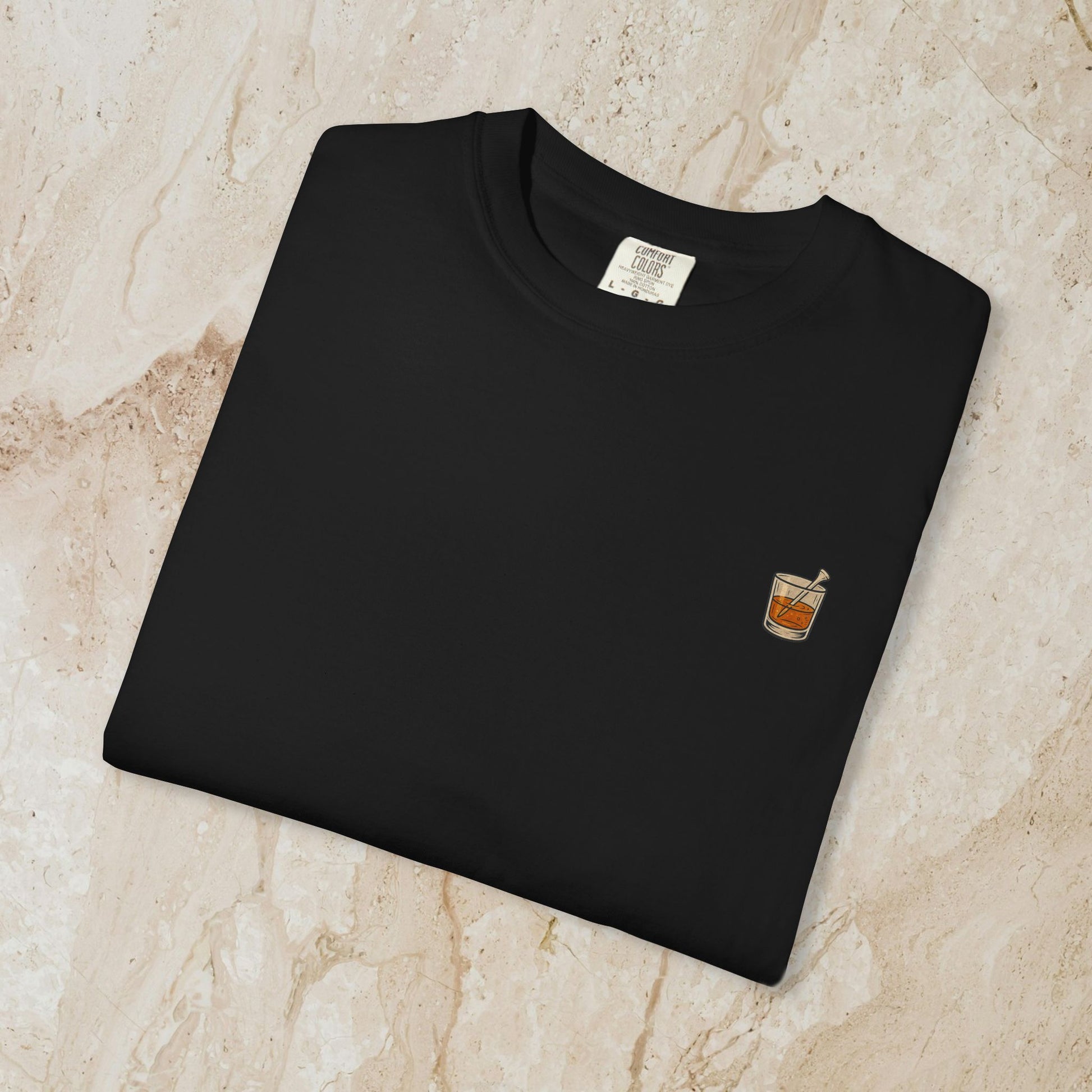 Golden Whiskey Dog Tee folded flat, highlighting the left chest pocket design with a whiskey drink illustration, perfect for relaxed style.