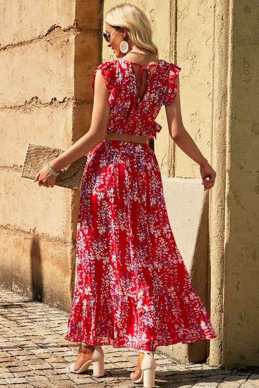 Back view of a Floral Print Tie-Back Cropped Top & Maxi Skirt Set, showcasing intricate details and flared design worn by a model outdoors.