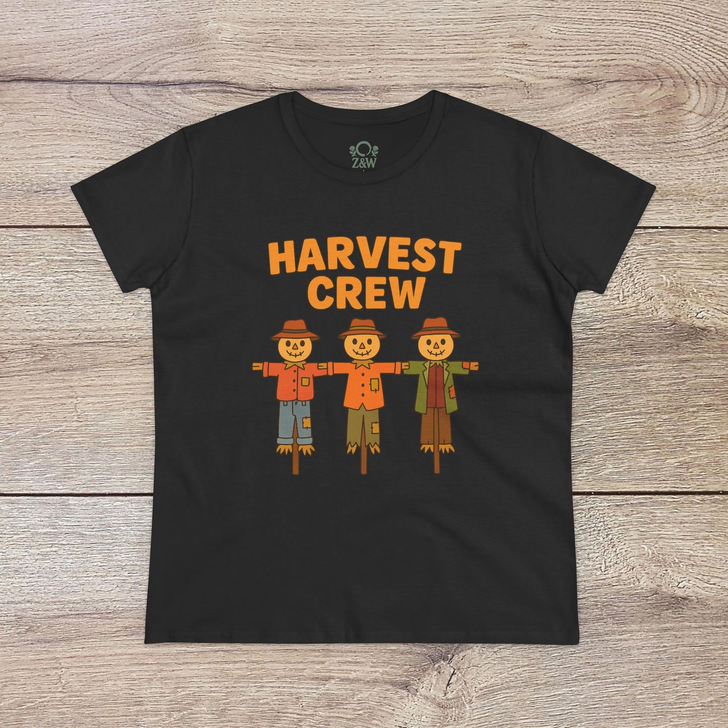 Harvest Crew Halloween T-Shirt in black displaying a fun depiction of three scarecrows, designed for comfort and style with 100% ring-spun cotton.