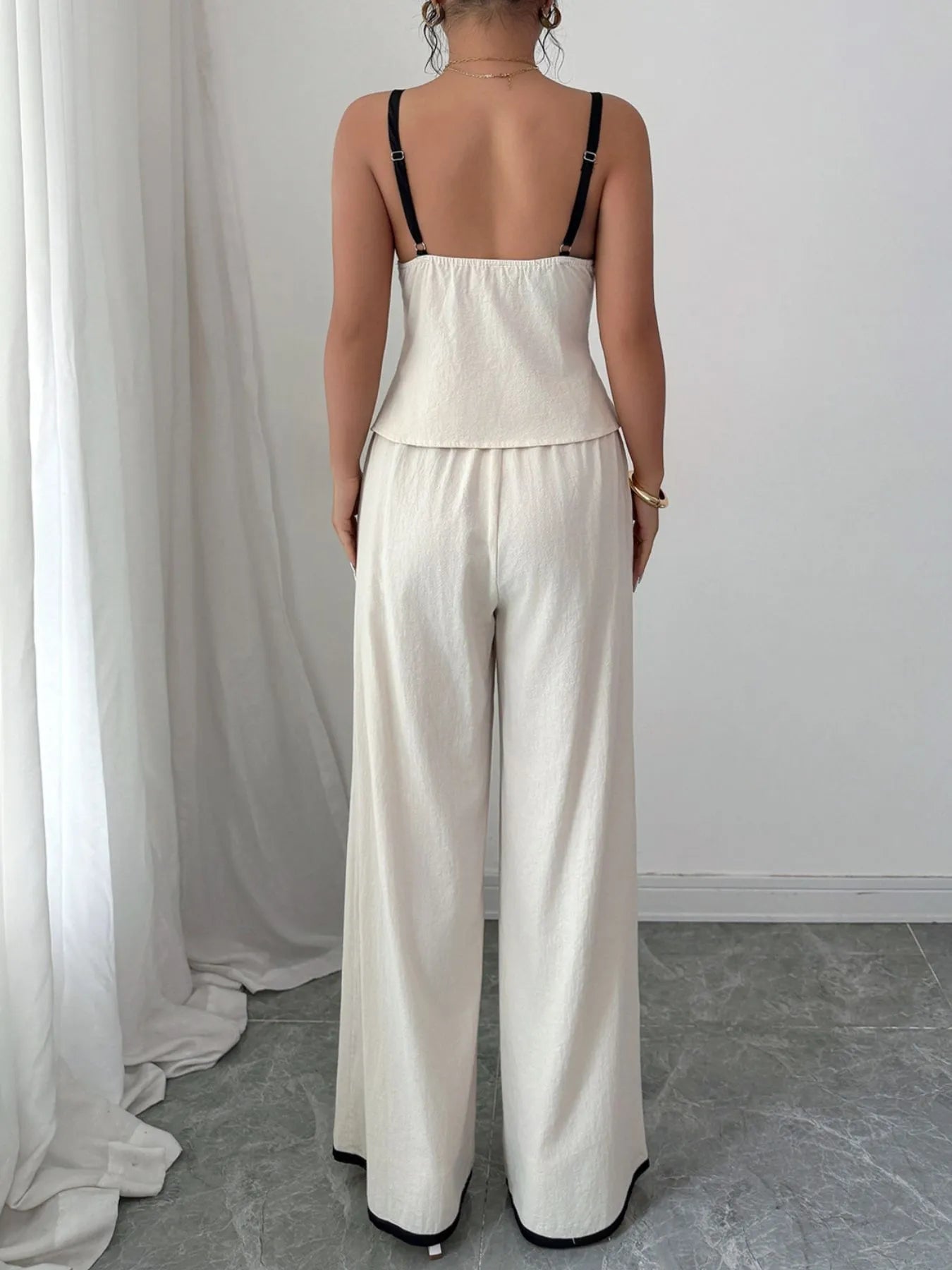 Back view of the Trendy 2-Piece Tie Front Cami and Pocketed Pants Set, emphasizing the fitted cami and airy wide-leg pants, crafted with 100% cotton.