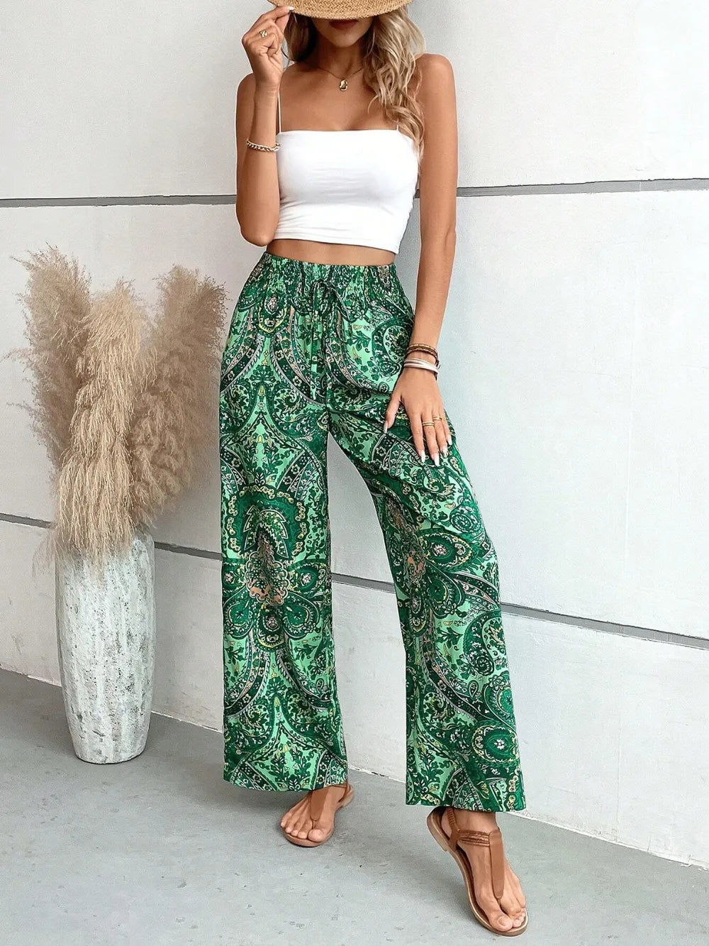 Trendy Printed Wide Leg Pants with Tied Detail in green paisley print, featuring a stylish tied detail, made of 100% opaque polyester, perfect for every occasion.