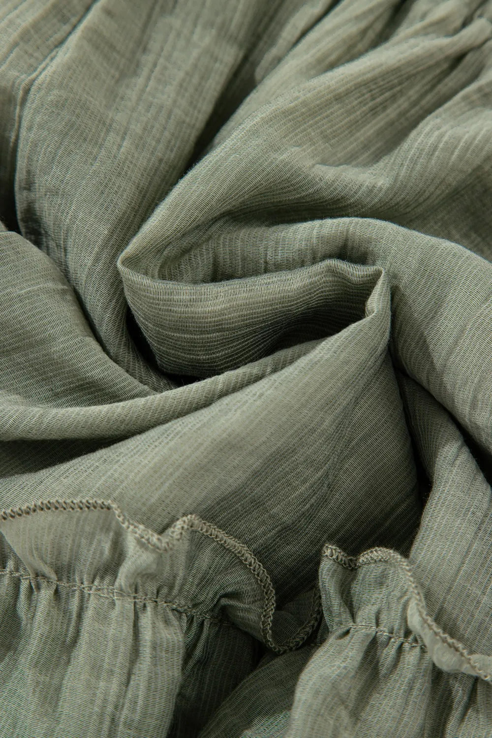 Detailed image of the fabric texture and folded ruffles of the Textured Tie Waist Ruffle Hem Shorts, highlighting softness and versatility.