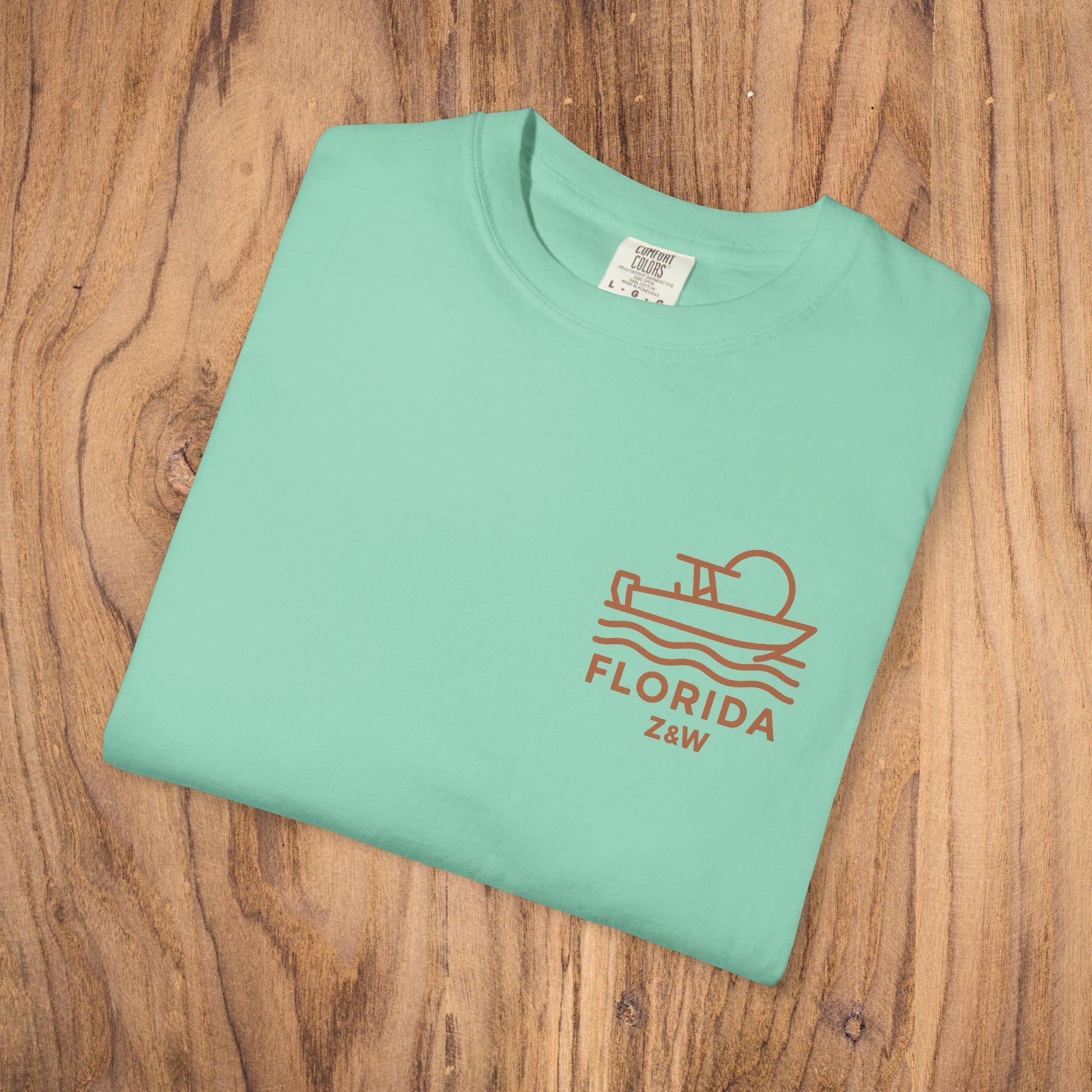 Unisex Florida Graphic Tee in mint green color, showcasing a stylish boating design, perfect for casual wear. This soft garment-dyed US cotton tee is available in sizes S-4XL.