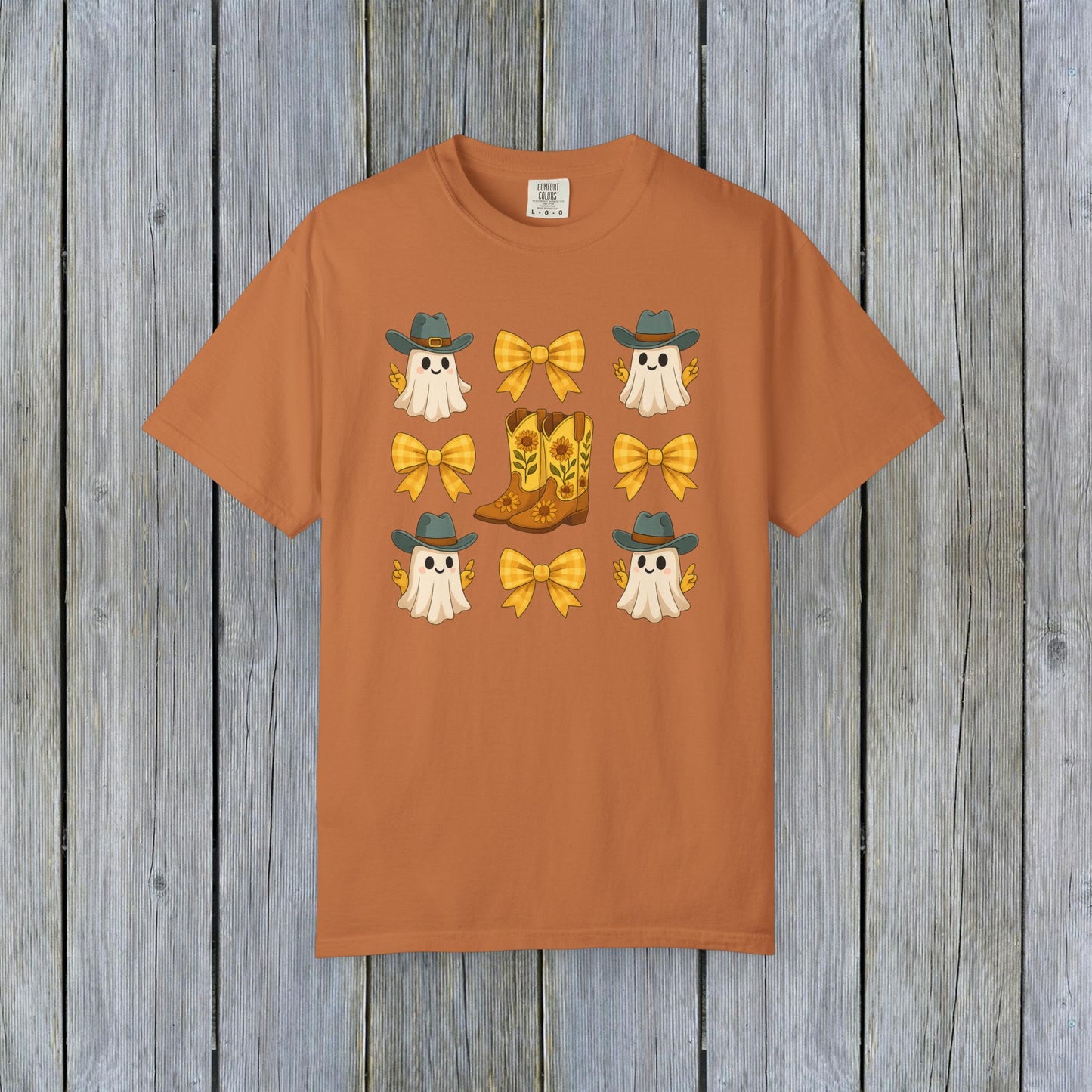 Cute Halloween T-Shirt showcasing adorable ghosts and cowboy boots, designed for unisex fall fashion. Crafted from eco-friendly fabric, great for Halloween festivities.