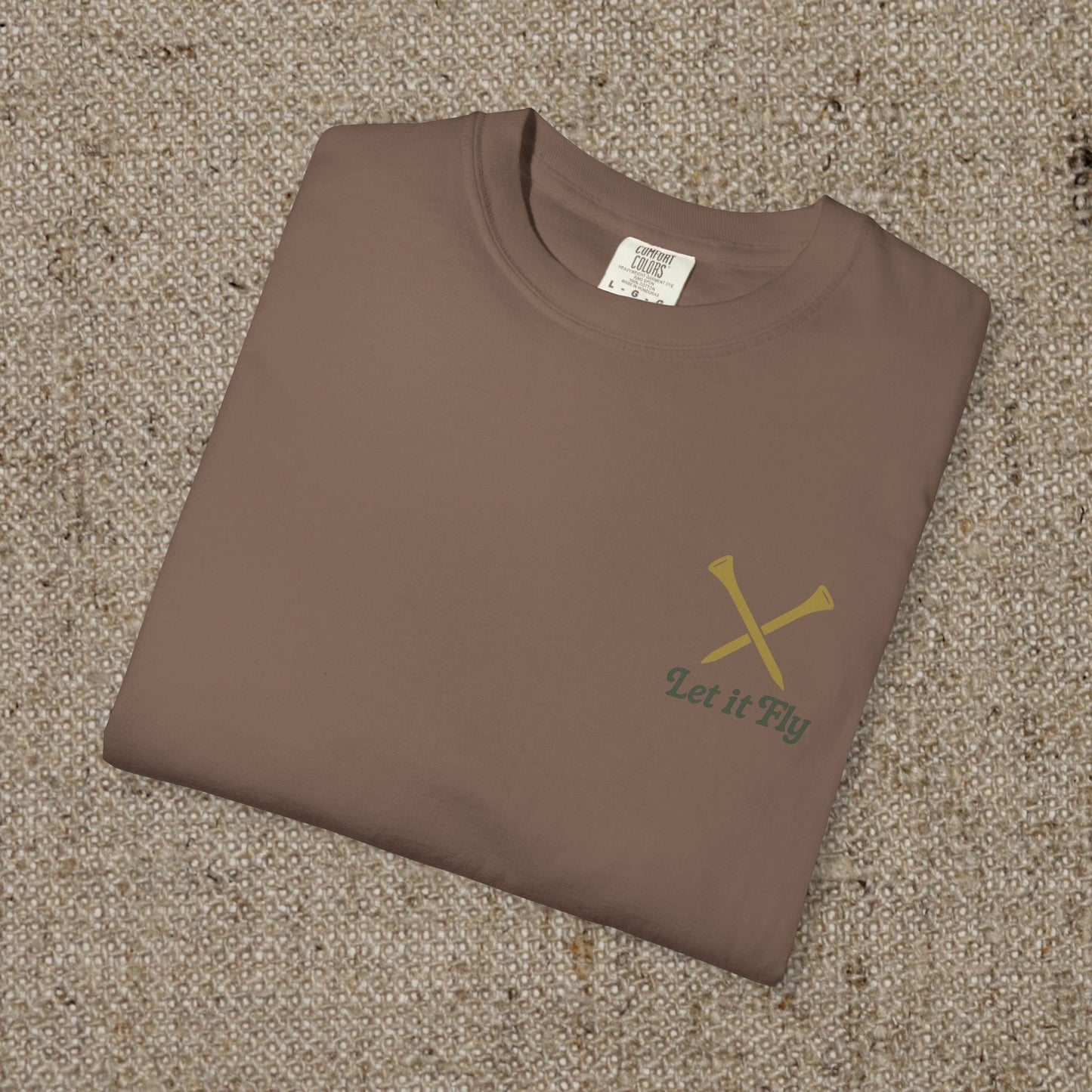 Folded Tee It High Let It Fly Graphic Tee in brown, featuring crossed golf clubs on the chest. A great choice for casual wear.