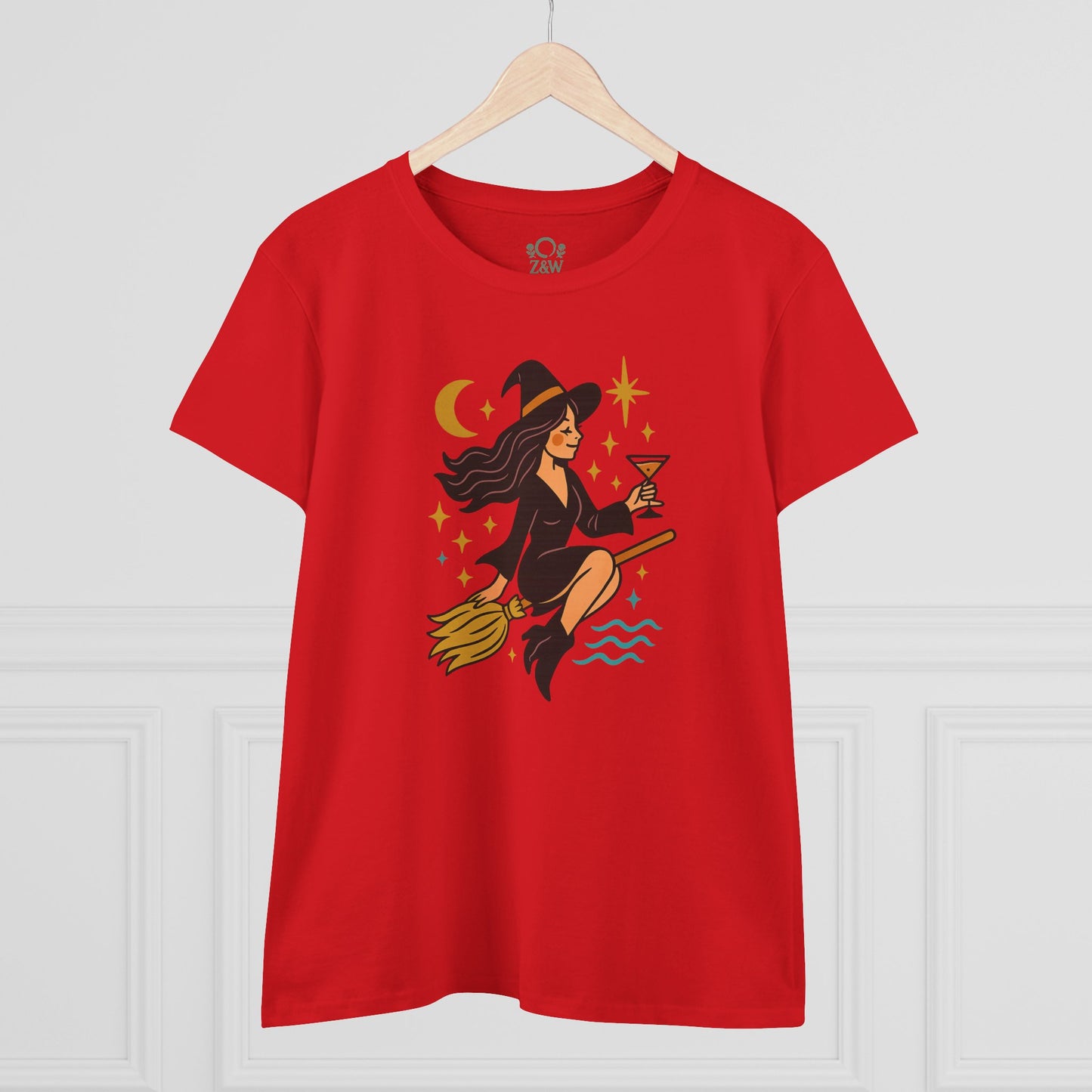 Witchy Night Out Tee in vibrant red featuring a witch with a cocktail, styled on a wooden hanger for a fashion-forward look.