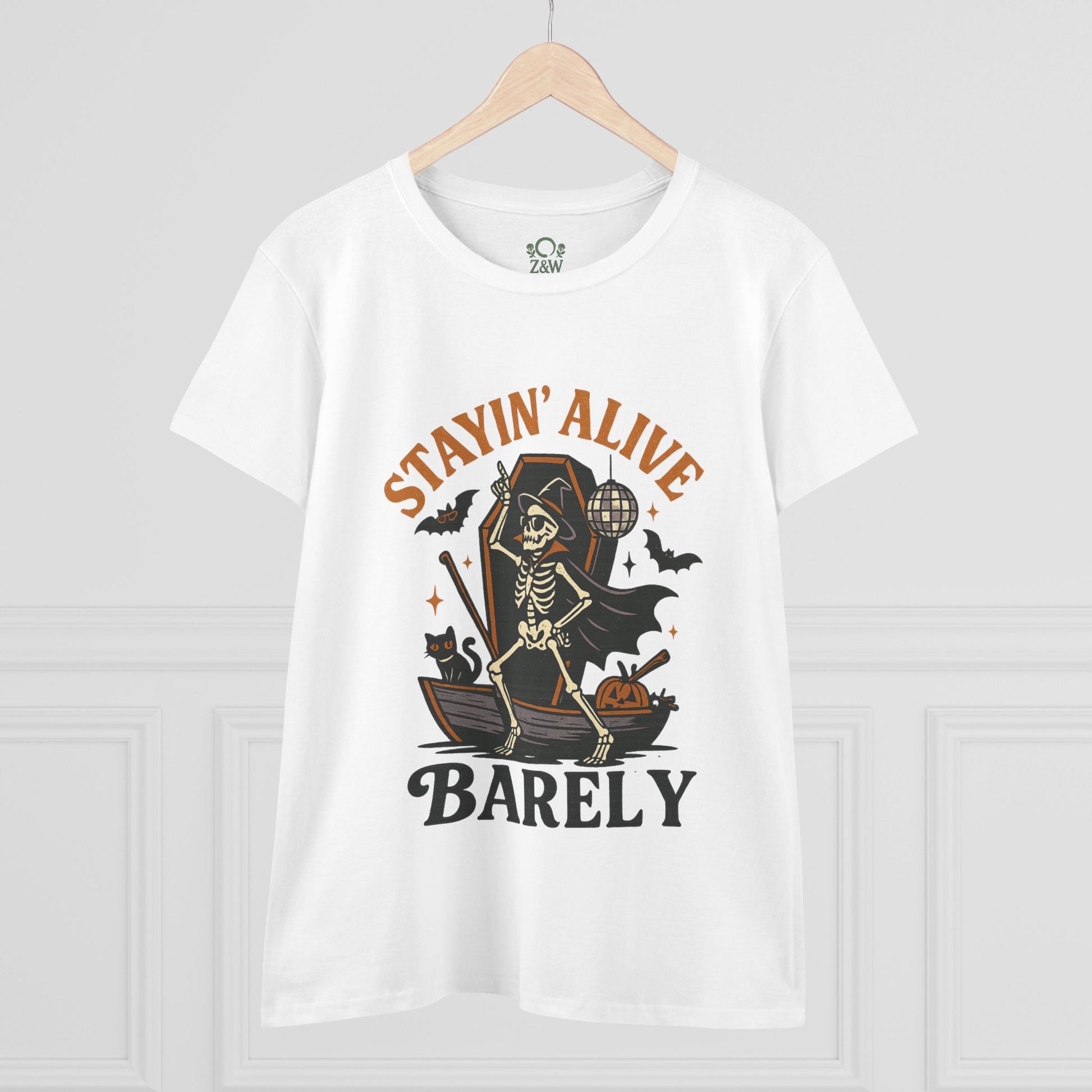 Front view of the Stayin’ Alive T-Shirt featuring a skeleton dressed in a cape for Halloween, embodying a playful spirit.