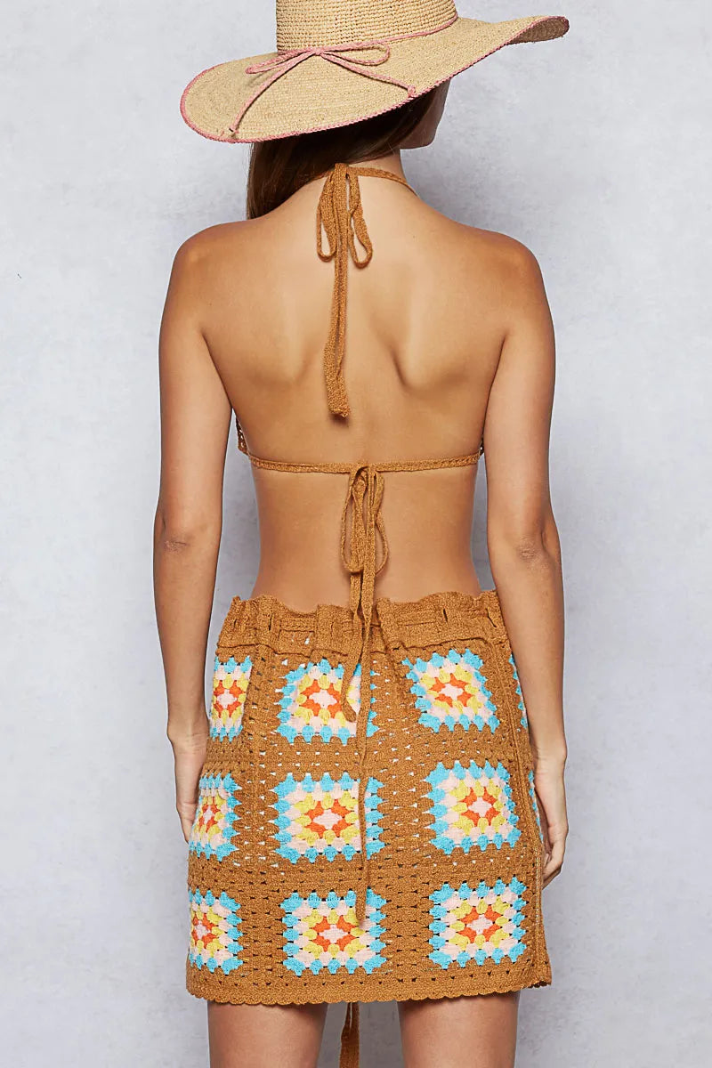 Back view of the Bohemian Crochet Halter Neck Cami & Skirt Sweater Set in Vibrant Orange & Turquoise, showcasing the intricate granny square pattern and the adjustable ties of the halter top, perfect for summer festivals and casual boho-chic styling.