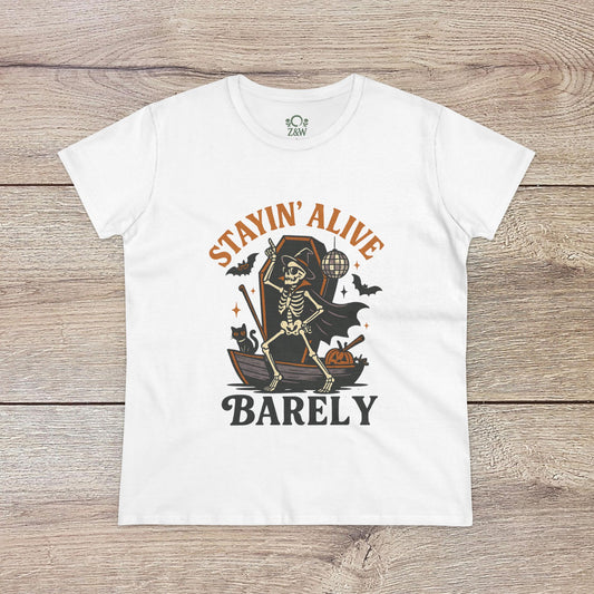 Stayin’ Alive T-Shirt in white showcasing a skeleton graphic and the humorous phrase 'BARELY', perfect for Halloween celebrations or casual wear.
