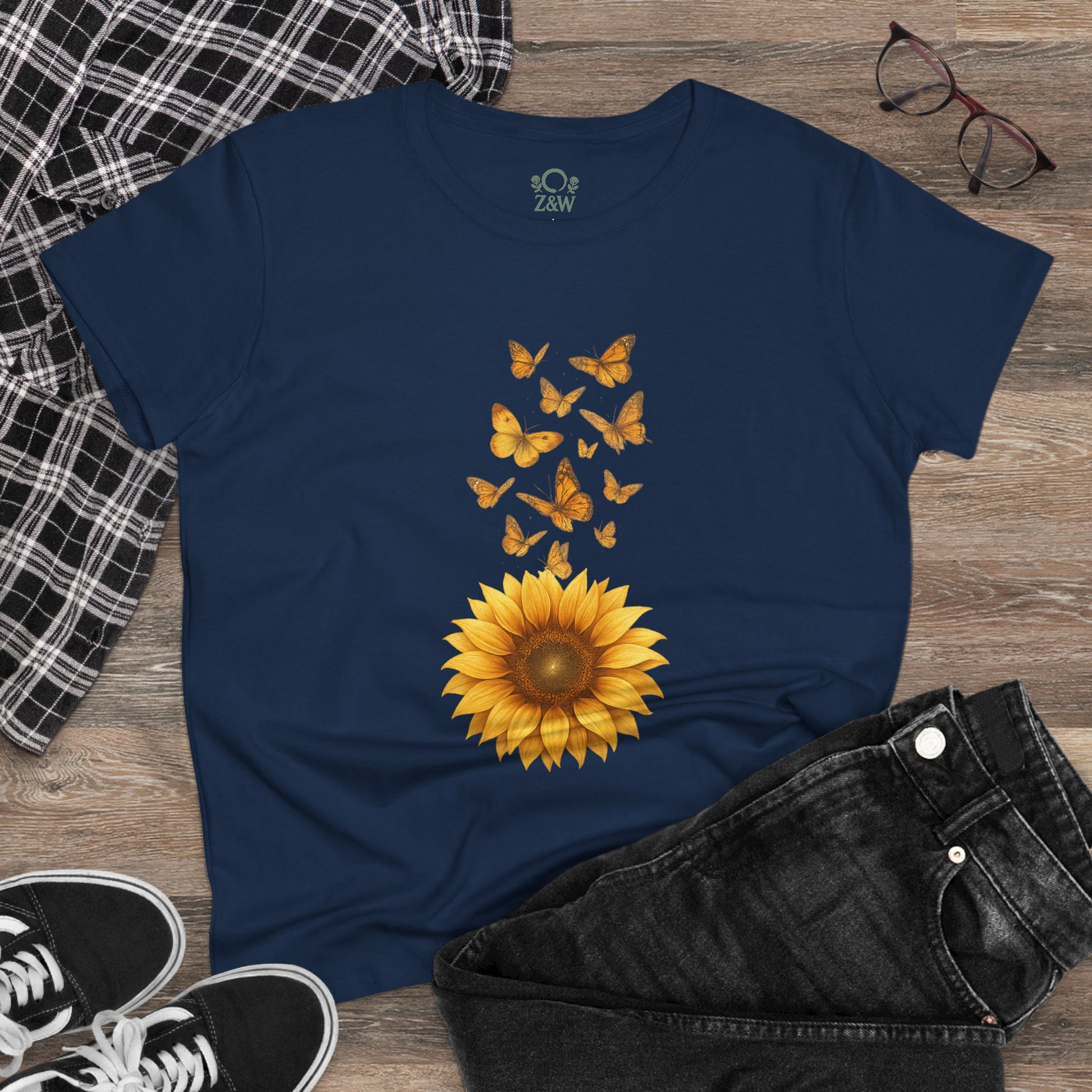 Sunflower & Butterflies Cotton Tee for Women - 100% Soft Cotton, Breathable, Durable Design, styled with a sunflower and butterflies, laid on a casual outfit with black jeans.