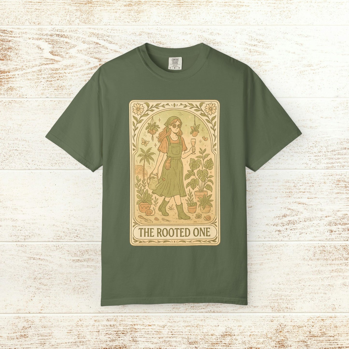 Rooted One Tarot Tee in olive green, featuring a unique design of a walking figure surrounded by plants. Ethically sourced cotton, perfect for eco-friendly fashion enthusiasts.