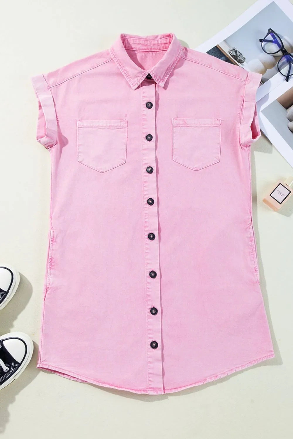 Flat lay of a Button Down Short Sleeve Denim Dress with Pockets in pink, made of 100% cotton, accompanied by stylish accessories.