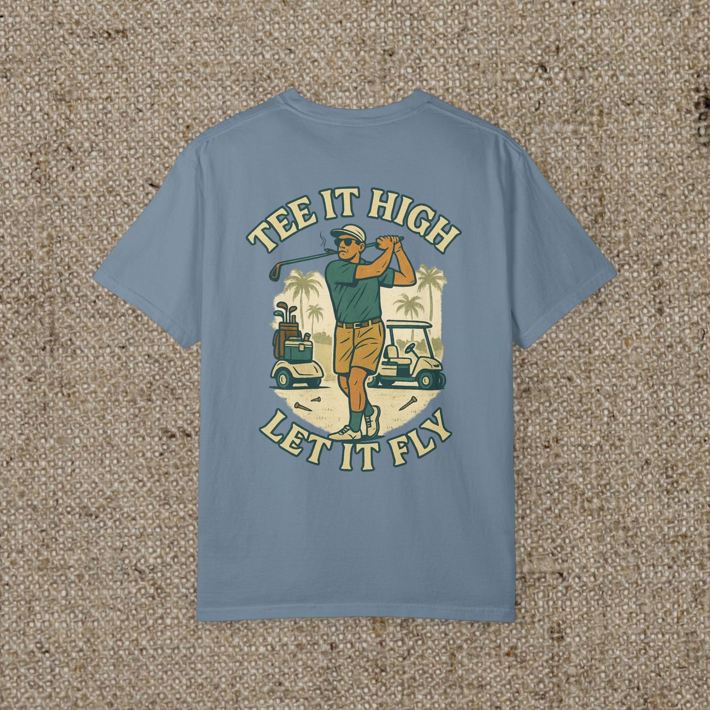 Tee It High Let It Fly Graphic Tee in sky blue, showcasing a vibrant illustration of a golfer swinging, ideal for casual wear on and off the golf course.