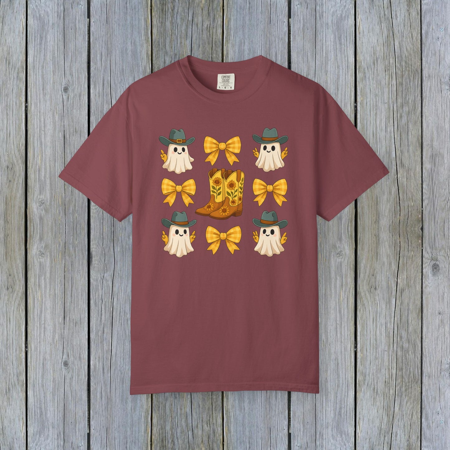 Cute Halloween T-Shirt featuring ghosts and cowboy boots, perfect for fall fashion. Made from eco-friendly fabric, this unisex tee is great for seasonal gatherings.