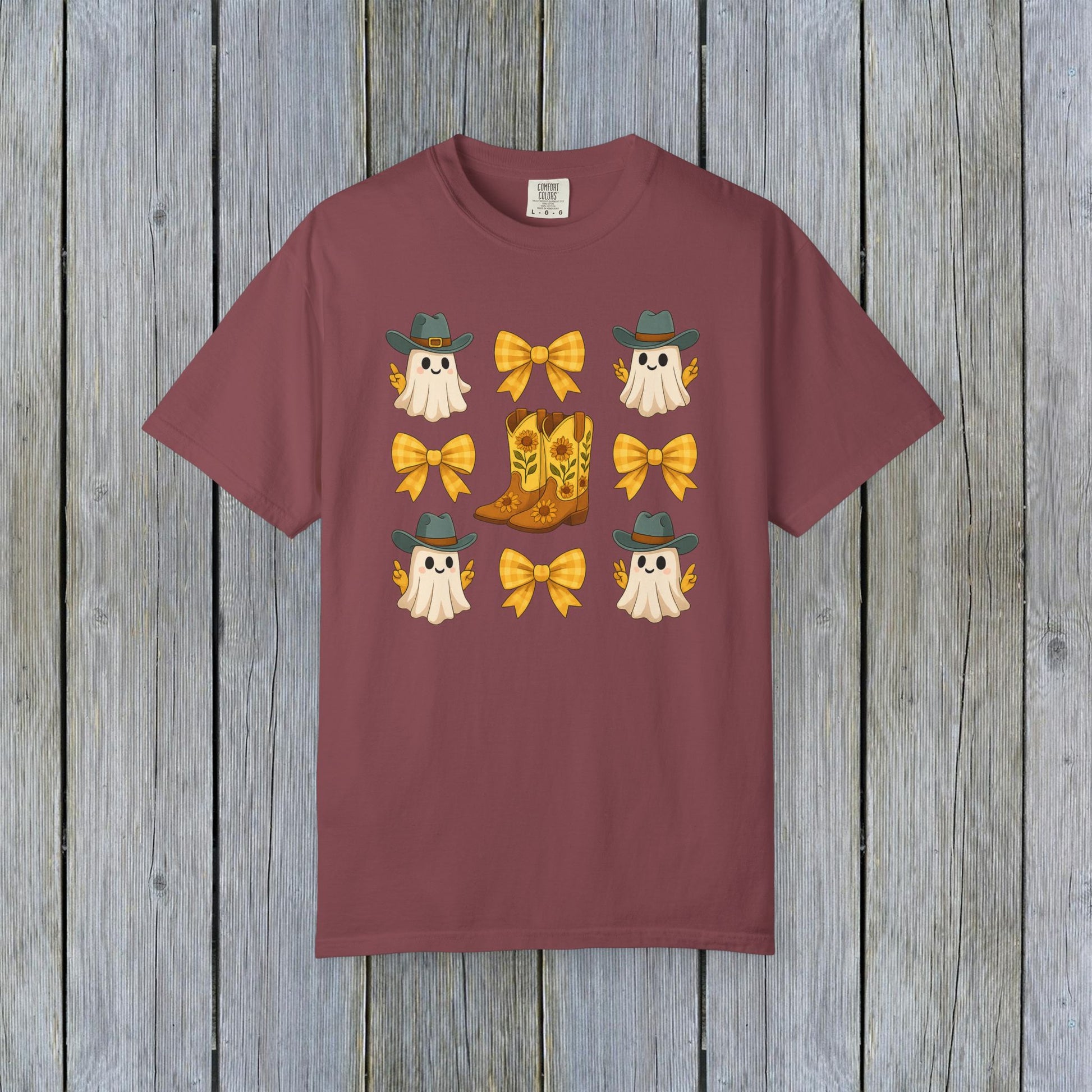 Cute Halloween T-Shirt featuring ghosts and cowboy boots, perfect for fall fashion. Made from eco-friendly fabric, this unisex tee is great for seasonal gatherings.