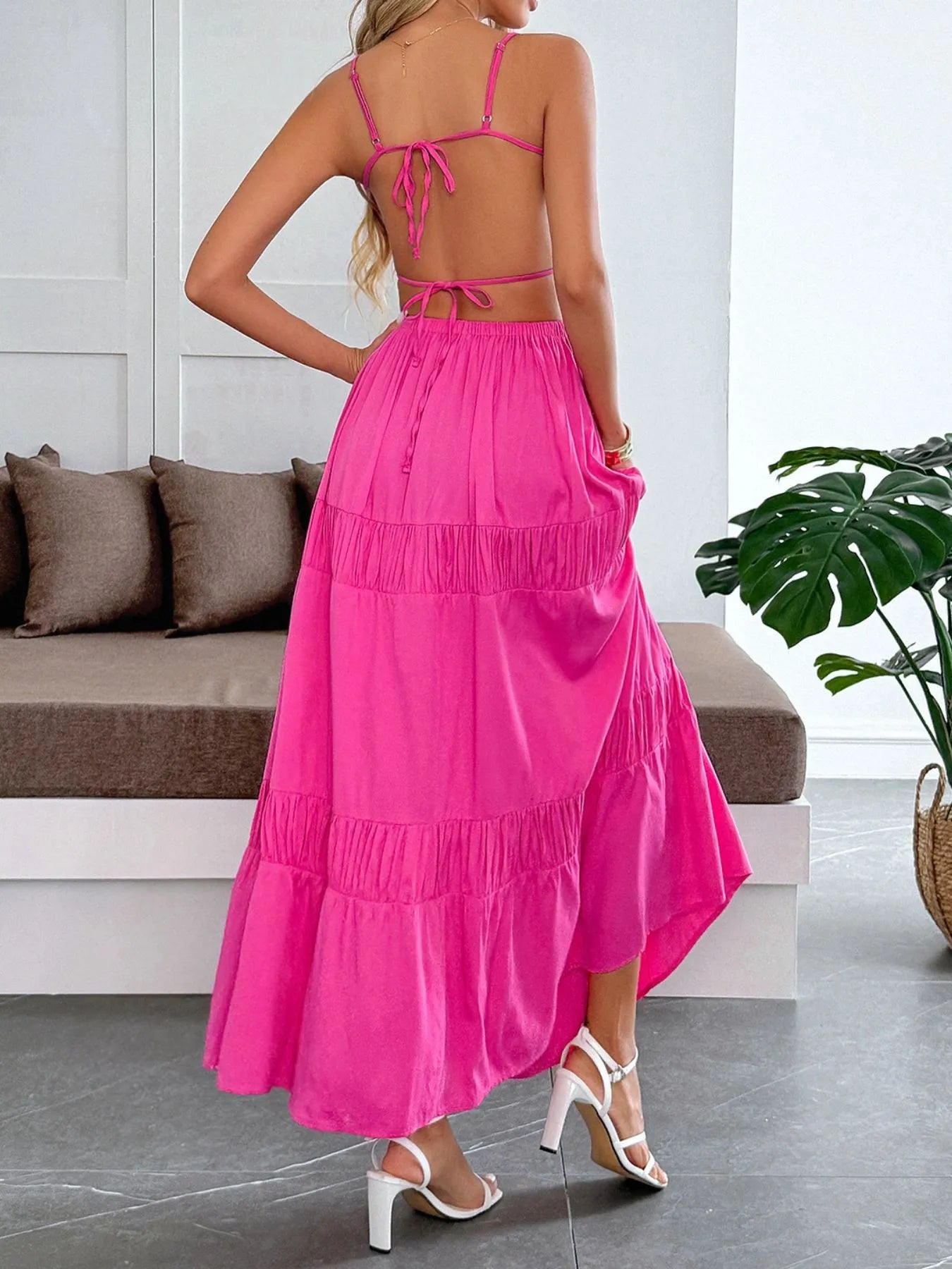 Stylish Tied Back Tiered Maxi Cami Dress in vibrant pink, showcasing a ruched back design and flowing tiered skirt in a chic indoor setting.