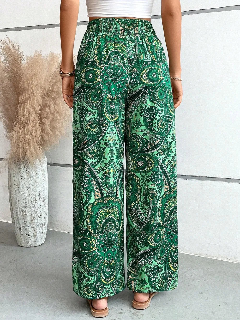 Side view of the Trendy Printed Wide Leg Pants with Tied Detail, emphasizing the chic green paisley design and comfortable fit, perfect for any occasion.