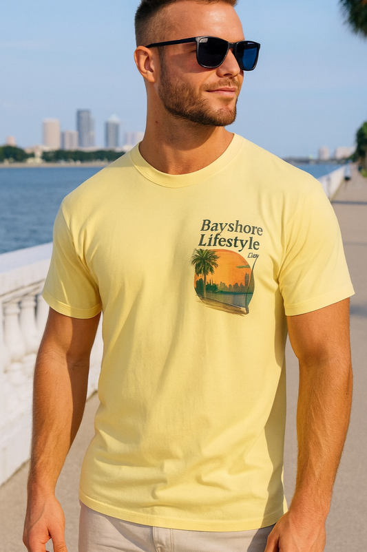 Bayshore Lifestyle Tee displayed by a model, featuring a vibrant yellow color and a stylish graphic design, made from 100% cotton lightweight fabric, ideal for any season.
