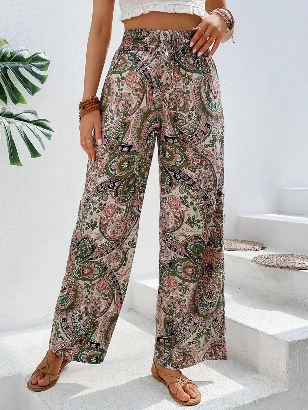 Trendy Printed Wide Leg Pants with Tied Detail featuring a bohemian floral design, perfect for every occasion. Made from 100% opaque polyester, styled with a casual top.