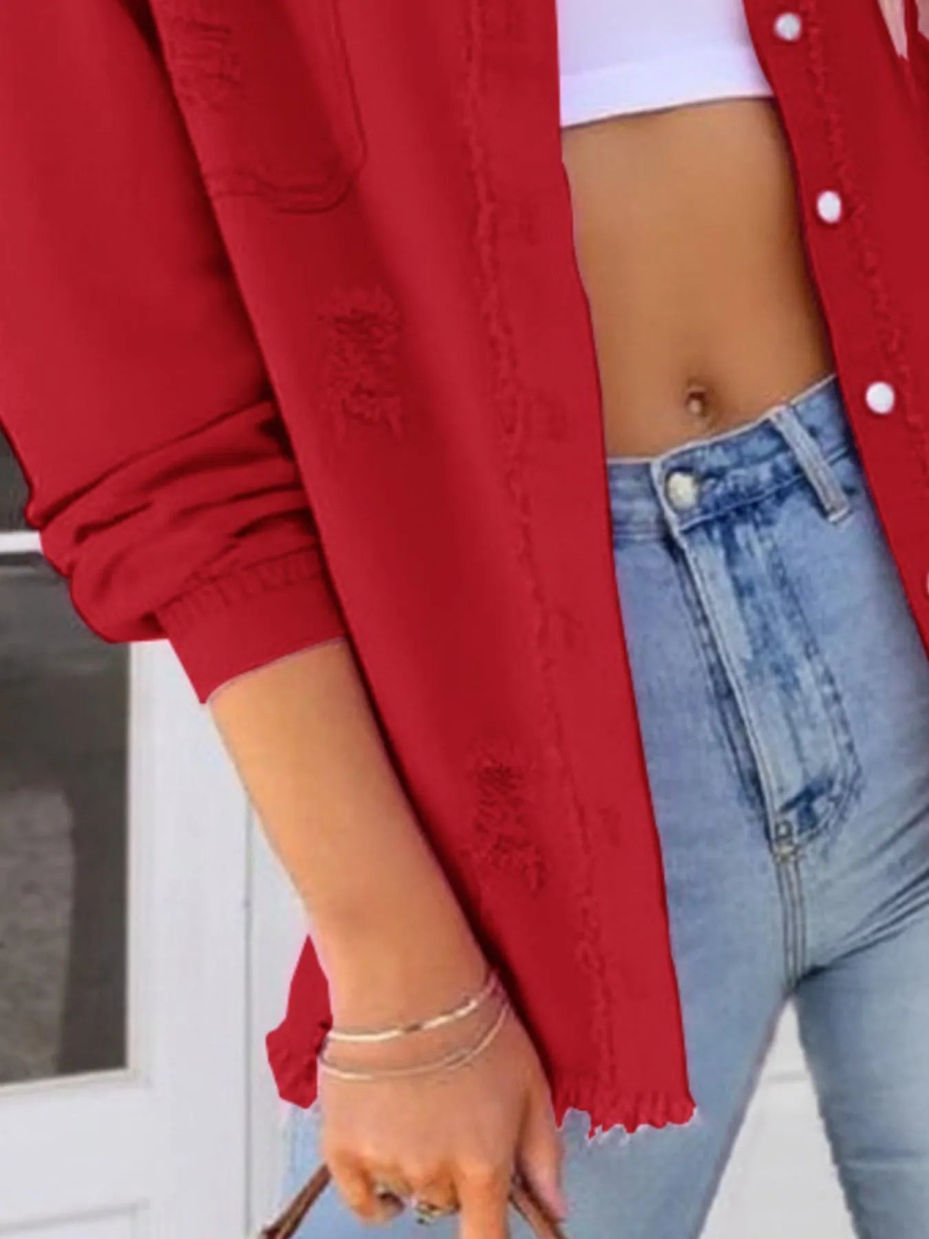 Side view of the Oversized Distressed Denim Jacket with Frayed Edges and Buttoned Pockets in red, featuring a relaxed fit ideal for trendy outfits.