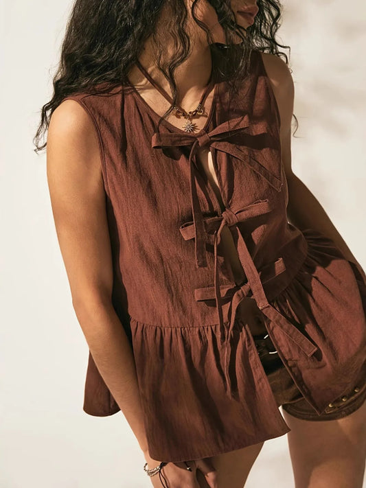 Trendsi Bow-Tie Peplum Tank Top with Ruched Detail, highlighting the intricate tied design and ruched detailing, ideal for adding elegance to everyday wear.