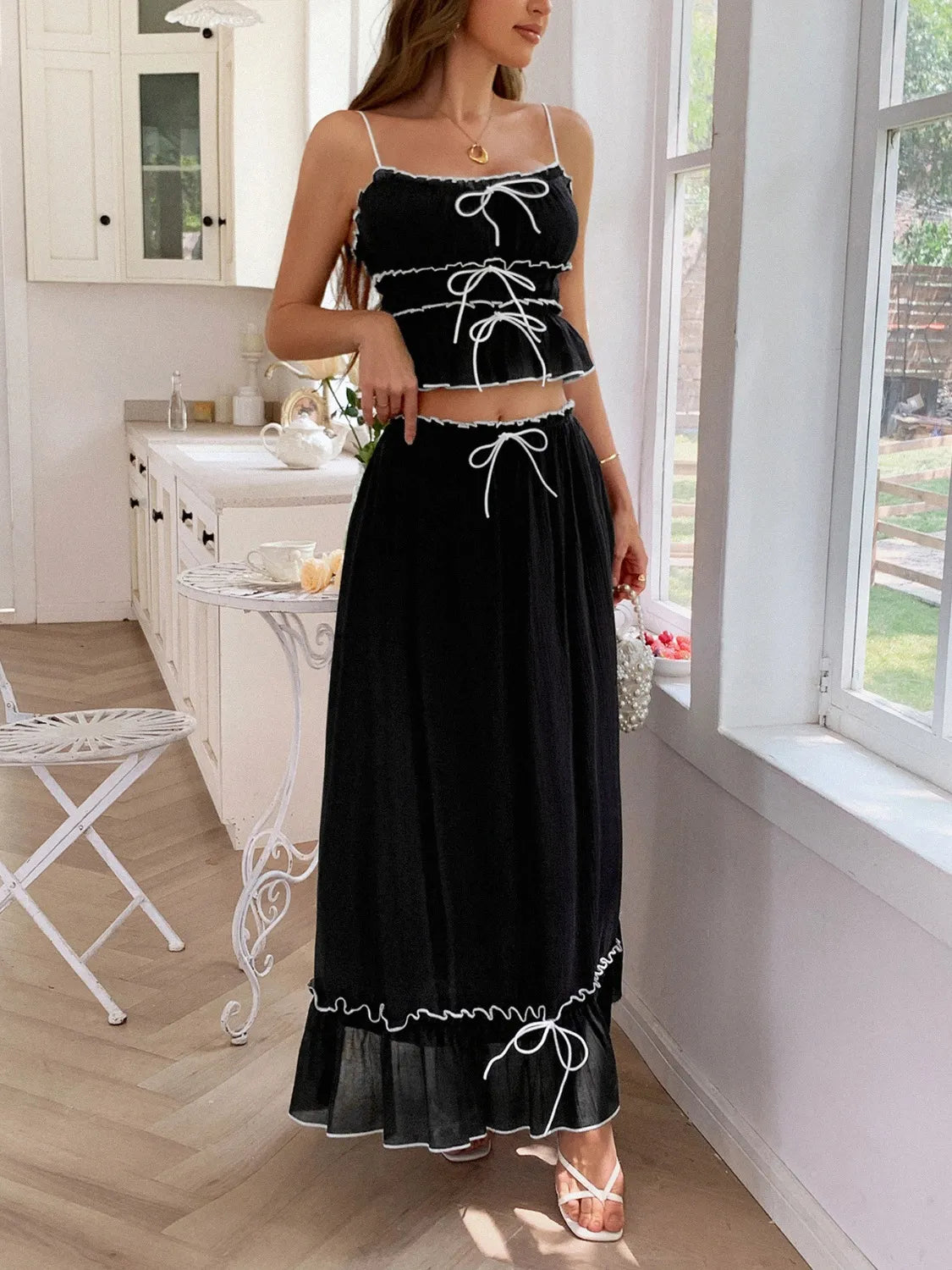 Close-up of a model wearing the black Two-Piece Frill Square Neck Cami and Ruched Skirt Set in Stretchy Lyocell Blend, highlighting the stylish ruched design and lightweight fabric.