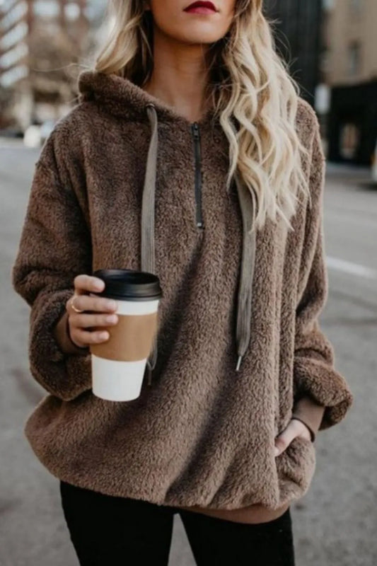 Cozy Full Size Teddy Hoodie with Quarter-Zip and Drawstring, Opaque & Slightly Stretchy, 100% Polyester, featuring a woman holding a coffee cup while wearing the stylish hoodie outdoors.