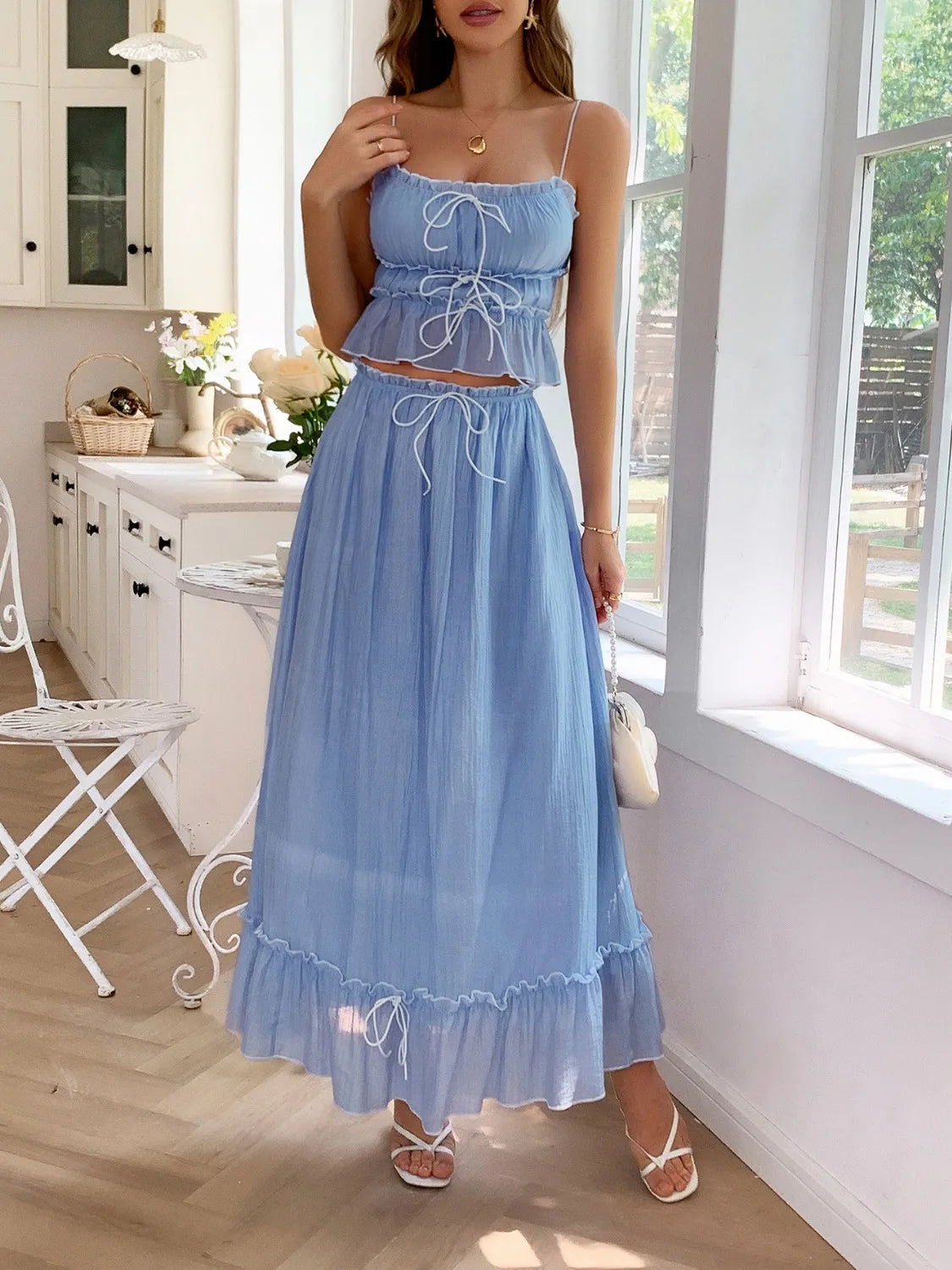 Front view of a model wearing a light blue Two-Piece Frill Square Neck Cami and Ruched Skirt Set in Stretchy Lyocell Blend, with tied accents that add a touch of femininity.