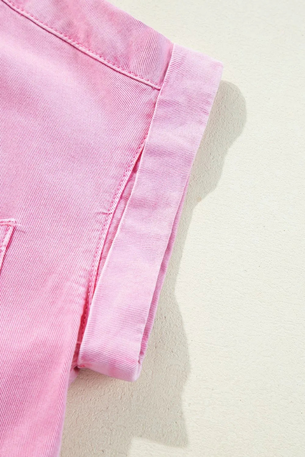 Detail of the rolled sleeve hem on a Button Down Short Sleeve Denim Dress with Pockets, highlighting the trendy style and fabric type.