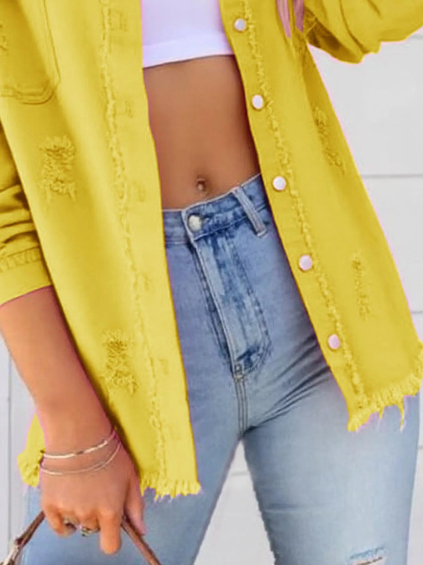 Close-up view of an Oversized Distressed Denim Jacket with Frayed Edges and Buttoned Pockets - Trendy Casual Outerwear, showcasing the frayed detailing and vibrant yellow color.