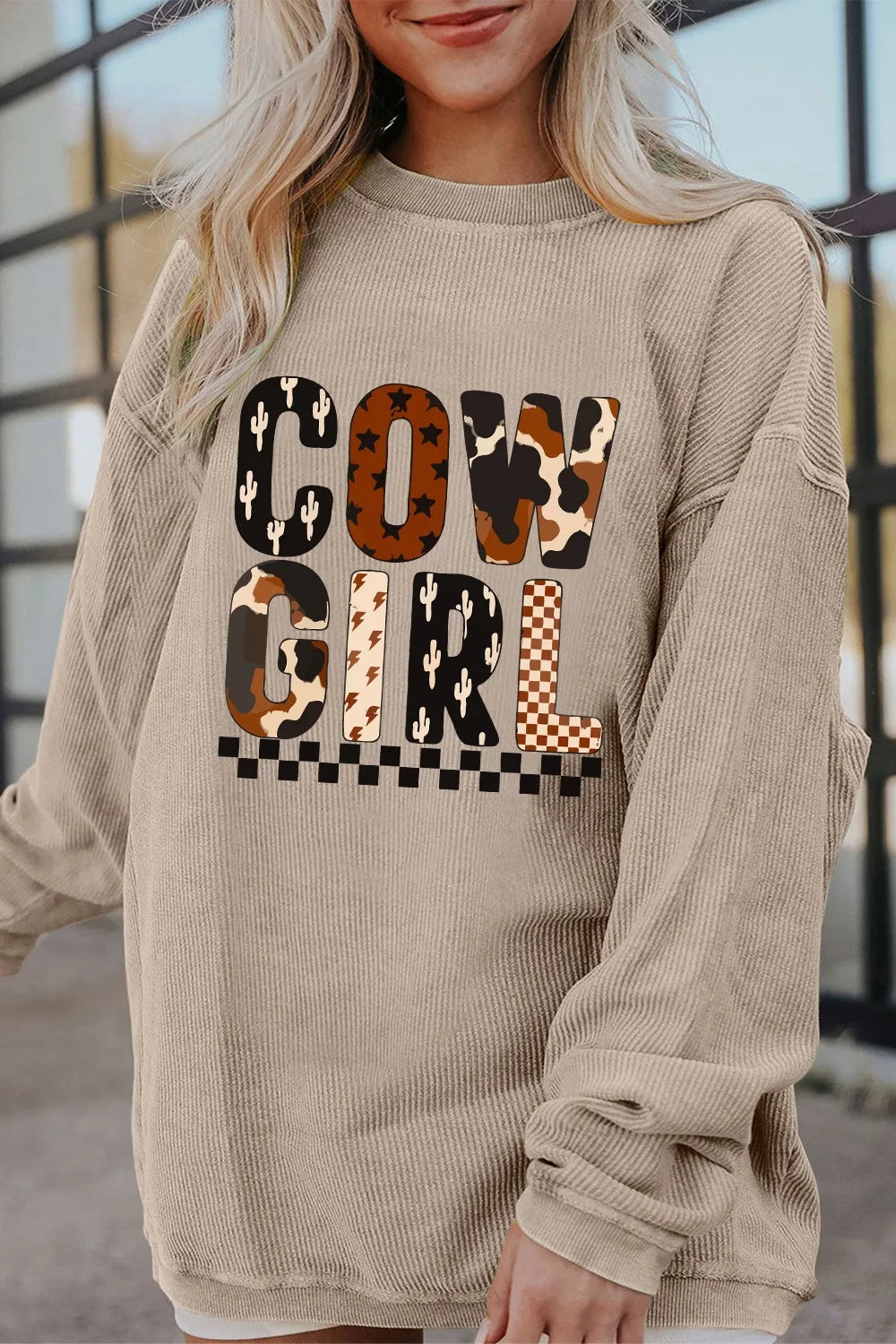 Close-up of a model wearing the Cowgirl Graphic Long Sleeve Sweatshirt, showcasing its unique design with vibrant graphics. Perfect for a trendy, casual look.