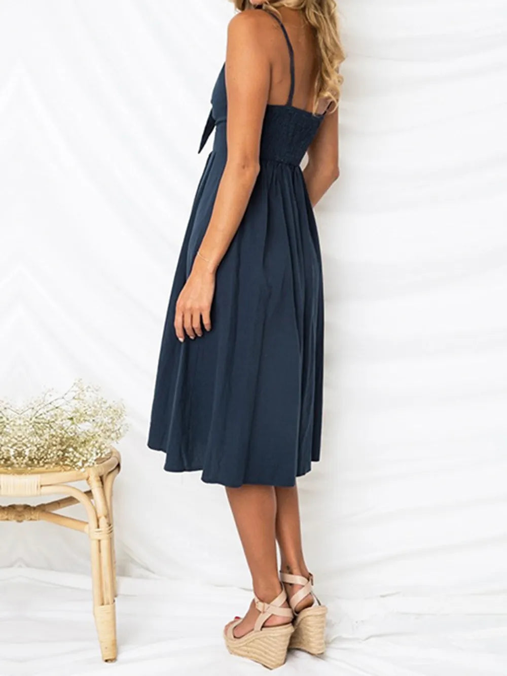Cutout Smocked Sweetheart Neck Cami Dress with Decorative Button and Opaque Design, showcasing the back view on a model, perfect for summer outings.