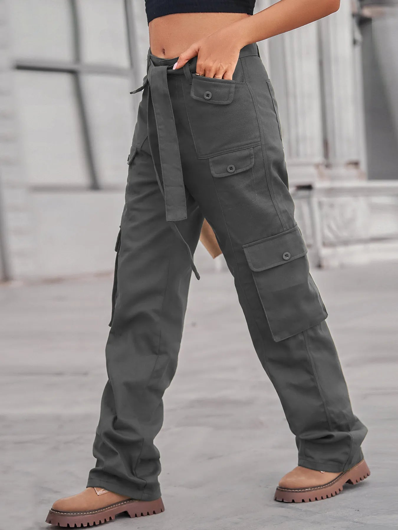 Trendy high-waisted multi-pocket cargo jeans in gray, designed for comfort and style, paired with chic footwear.